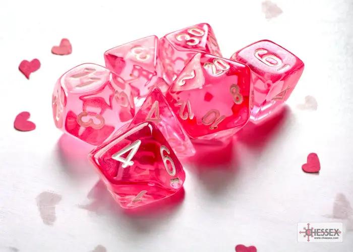 Mini 7-die set from Chessex featuring pink and transparent dice, perfect for tabletop role-playing games.