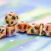 Black 7-Die set with festive circus-themed designs from THE MIGHTY HOBBY SHOP, featuring colorful patterns and numbered faces.