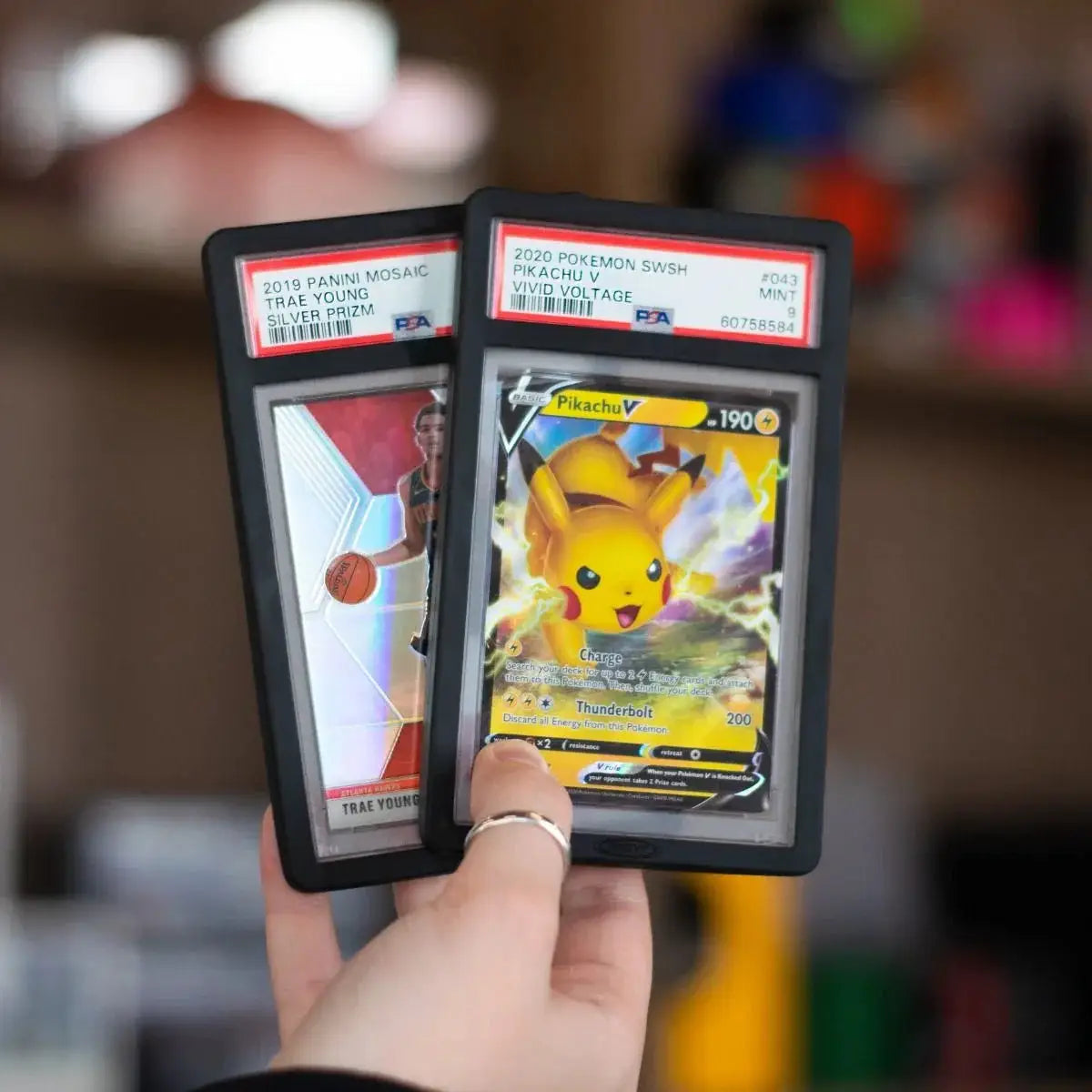 Black PSA slab bumpers for trading cards, featuring THE MIGHTY HOBBY SHOP branding and protective card display design.