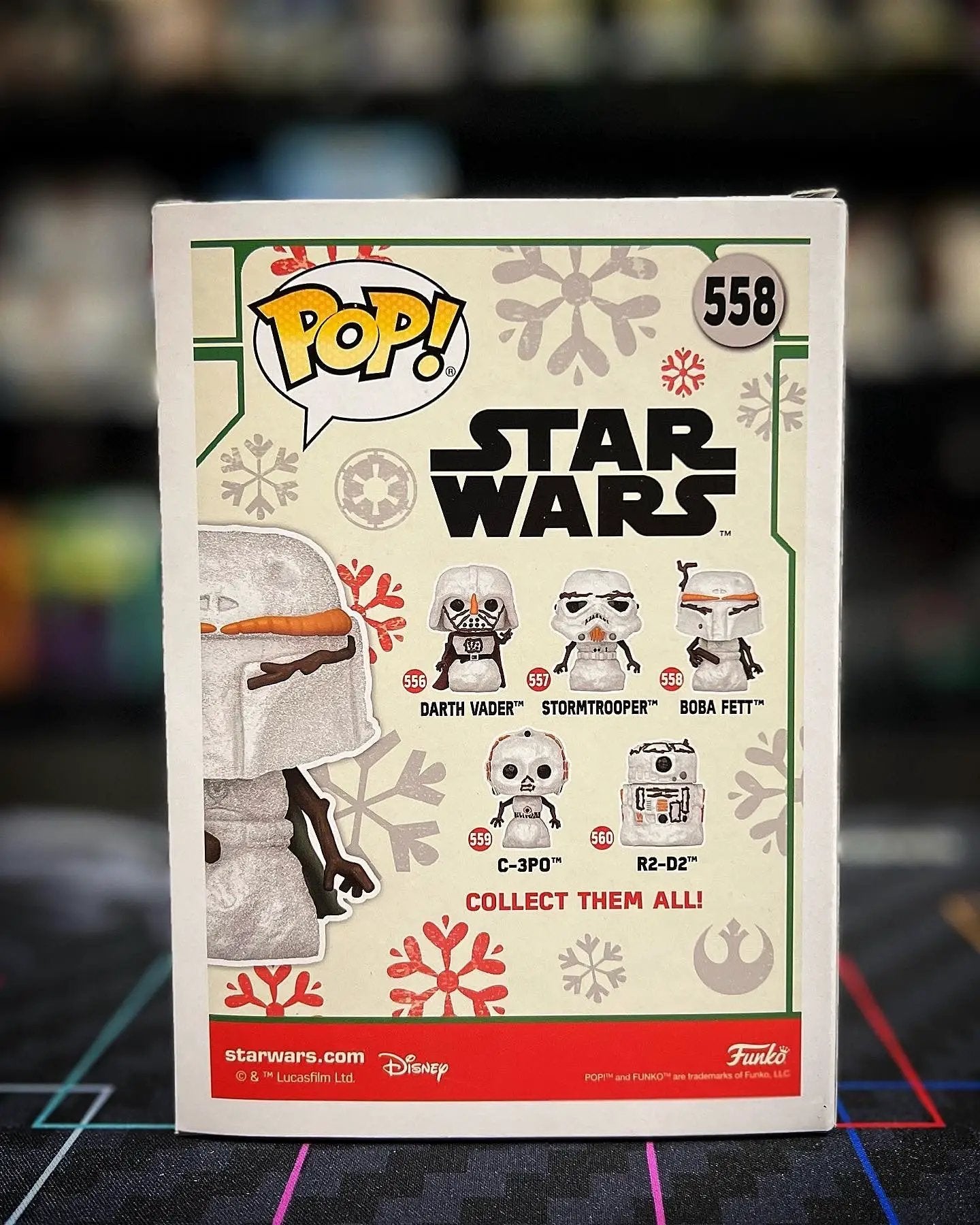 Pop! Star Wars Holiday Boba Fett vinyl figure by THE MIGHTY HOBBY SHOP, featuring Boba Fett in festive holiday attire.