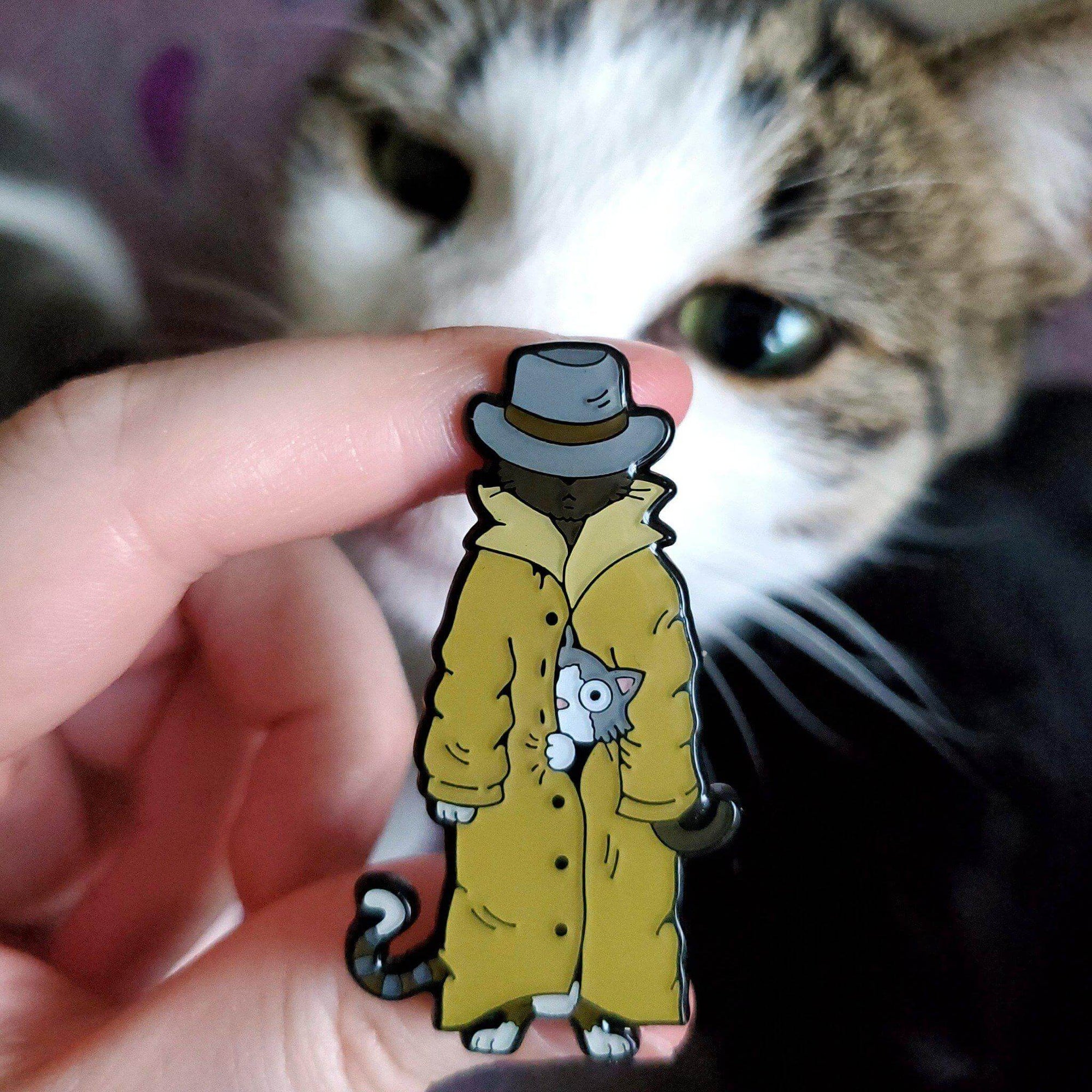 Kolorspun enamel pin featuring three cats in a trench coat design, perfect for cat lovers and pin collectors.
