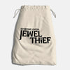 Comic book-themed dice bag featuring "Everyone Loves A Jewel Thief #2" with a 20-sided die inside, from Penguin Random House.