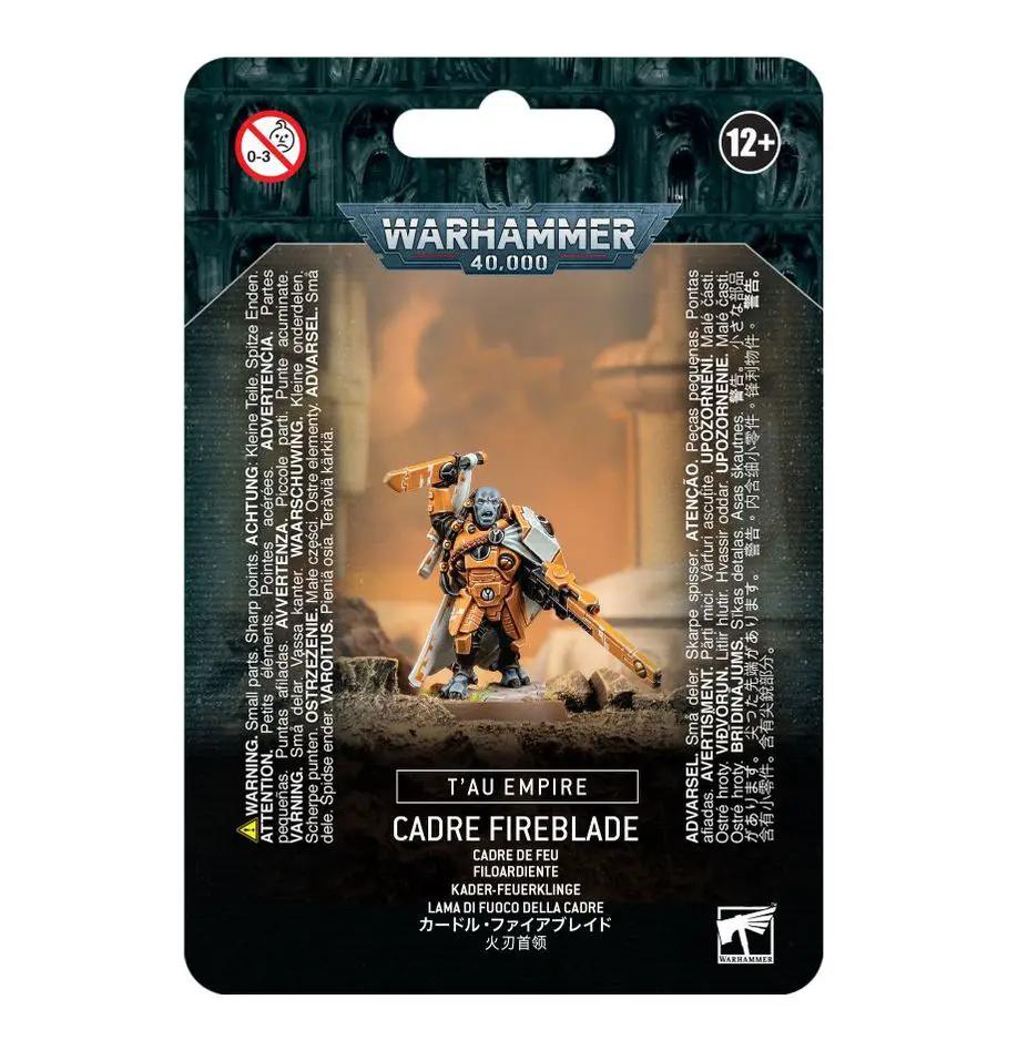 Warhammer 40,000 T'au Empire Cadre Fireblade miniature in detailed armor, posed with weapon, on a gaming base.