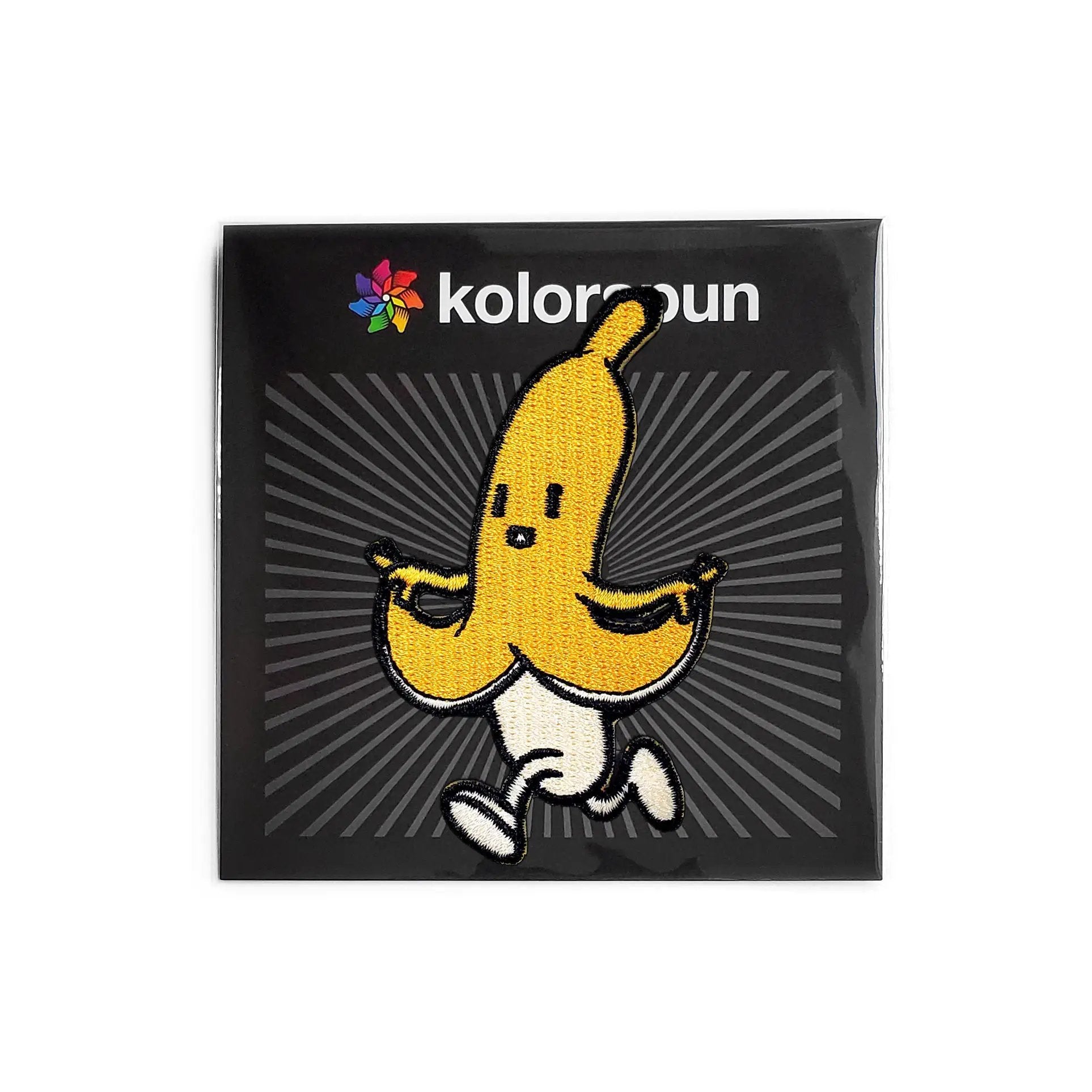 Kolorspun Skipping Banana Patch displayed in packaging, vibrant yellow fabric patch with banana design for clothing embellishments.