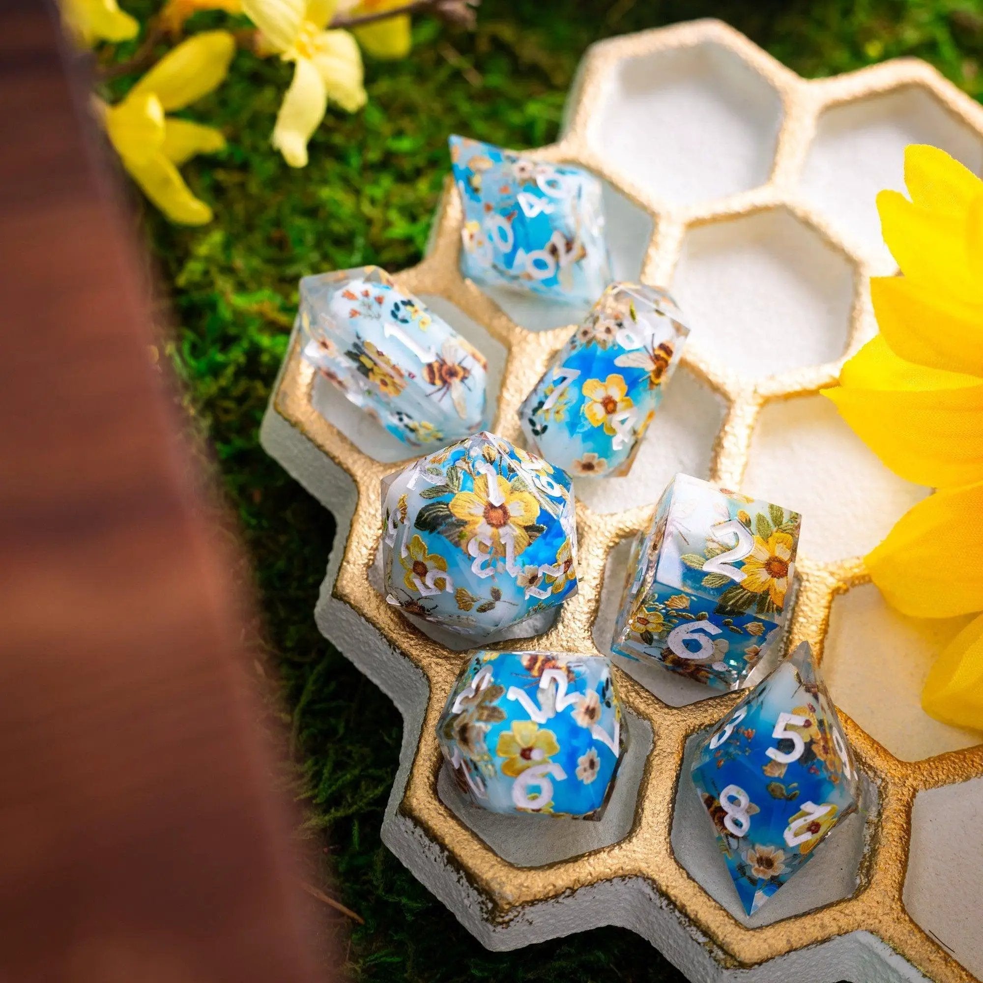 Handmade resin DND dice set featuring bees and flowers, crafted by Runic Dice, with detailed colorful bee and floral designs.