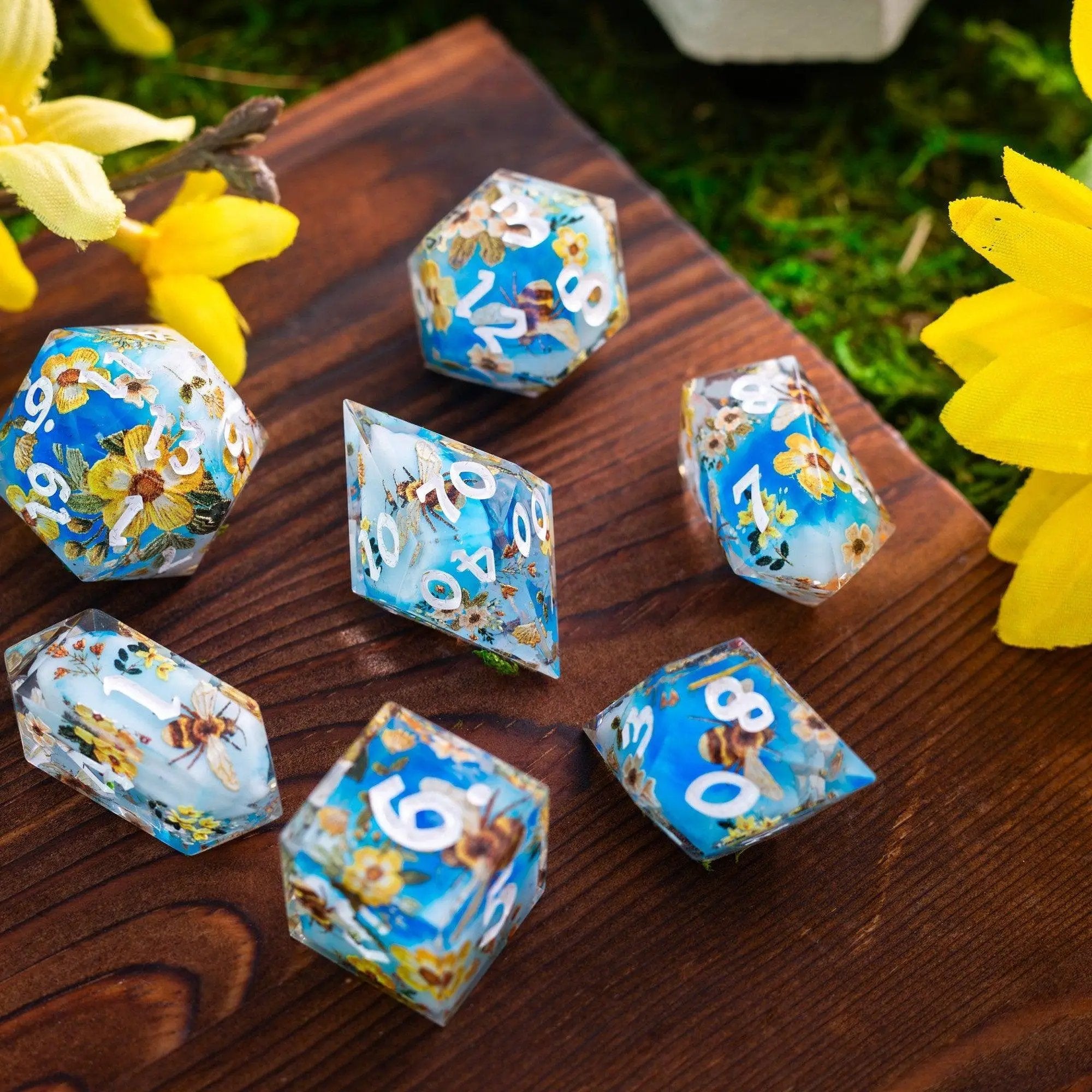 Set of handmade resin D&D dice with bees and flower design by Runic Dice, featuring six colorful and intricate pieces.