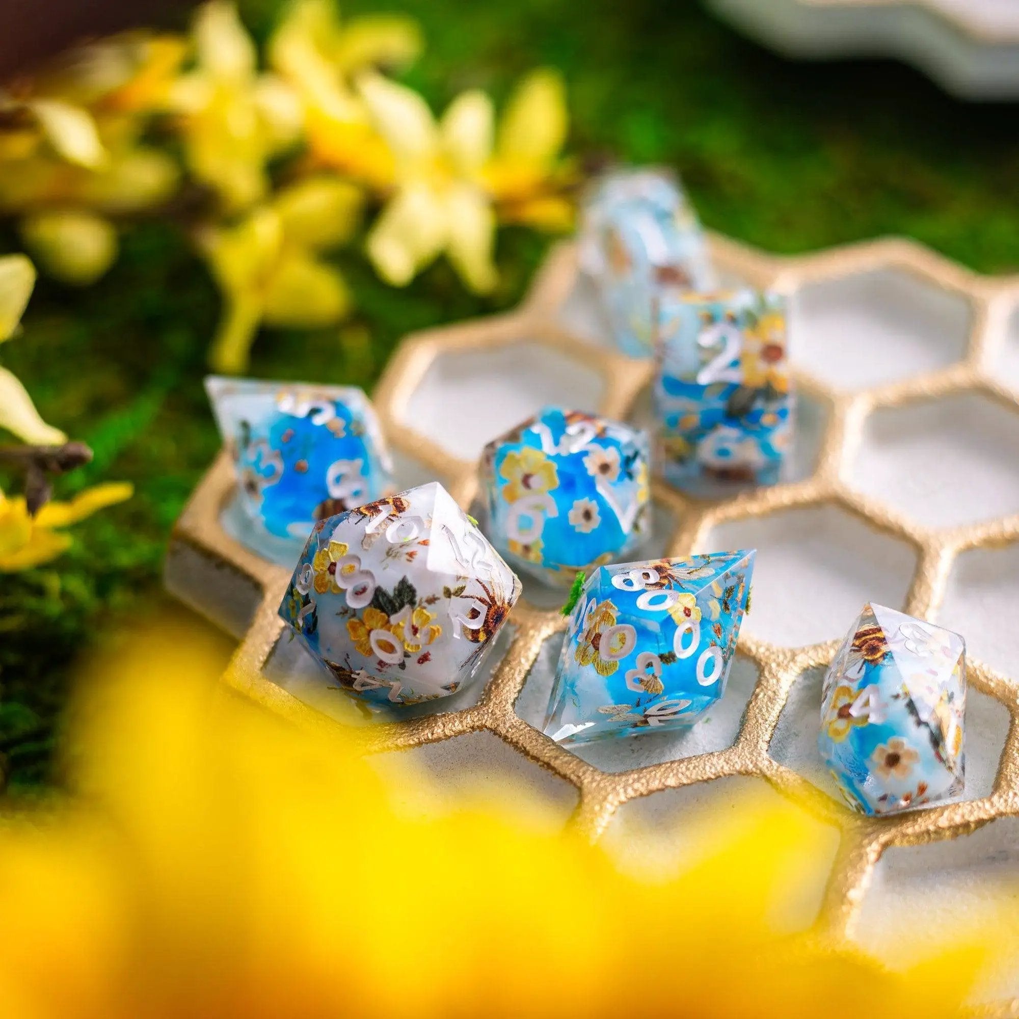 Handmade resin DND dice set featuring bees and flowers design by Runic Dice, with detailed bee and floral motifs.