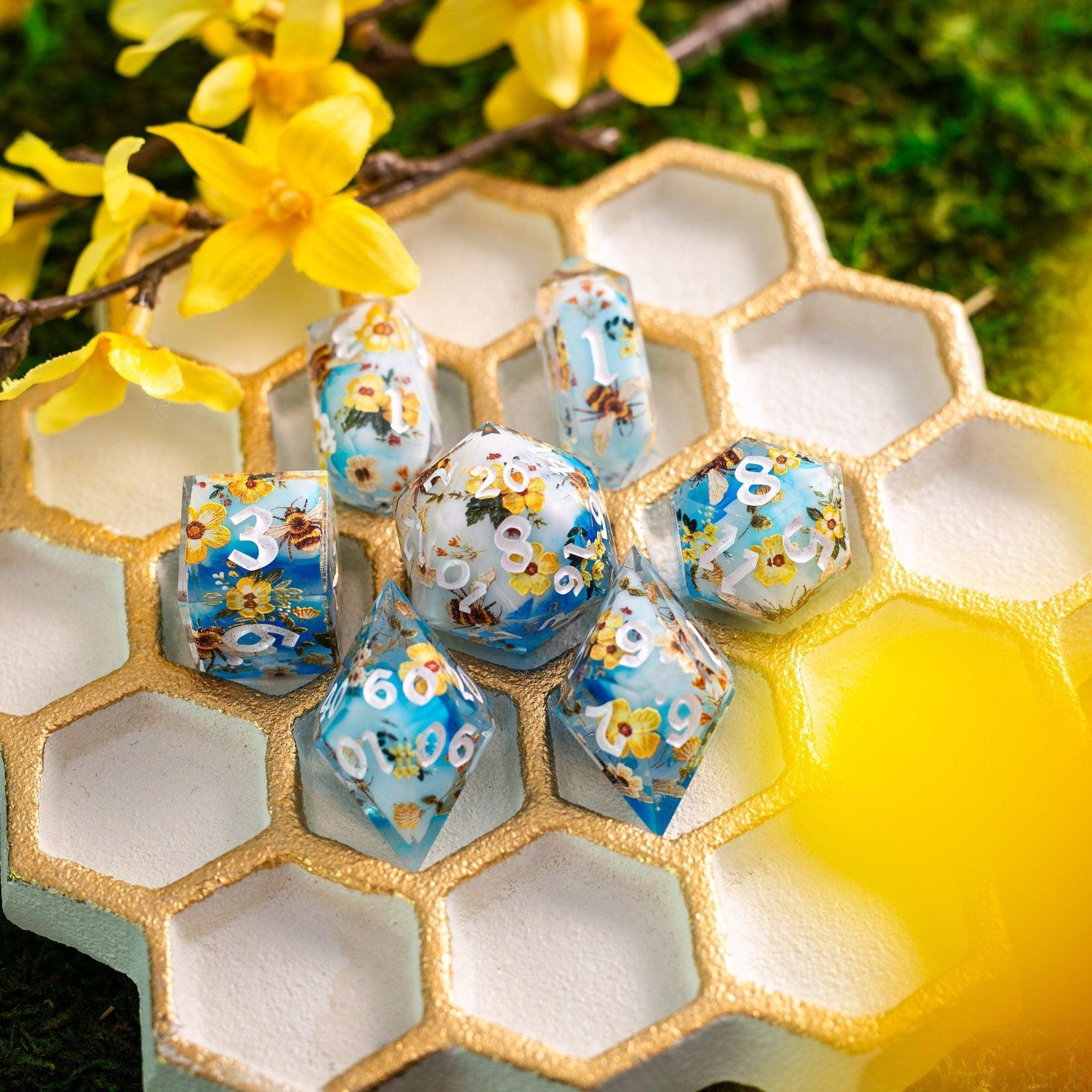 Handmade resin DND dice set featuring bees and flowers, crafted by Runic Dice, with intricate details and colorful design.
