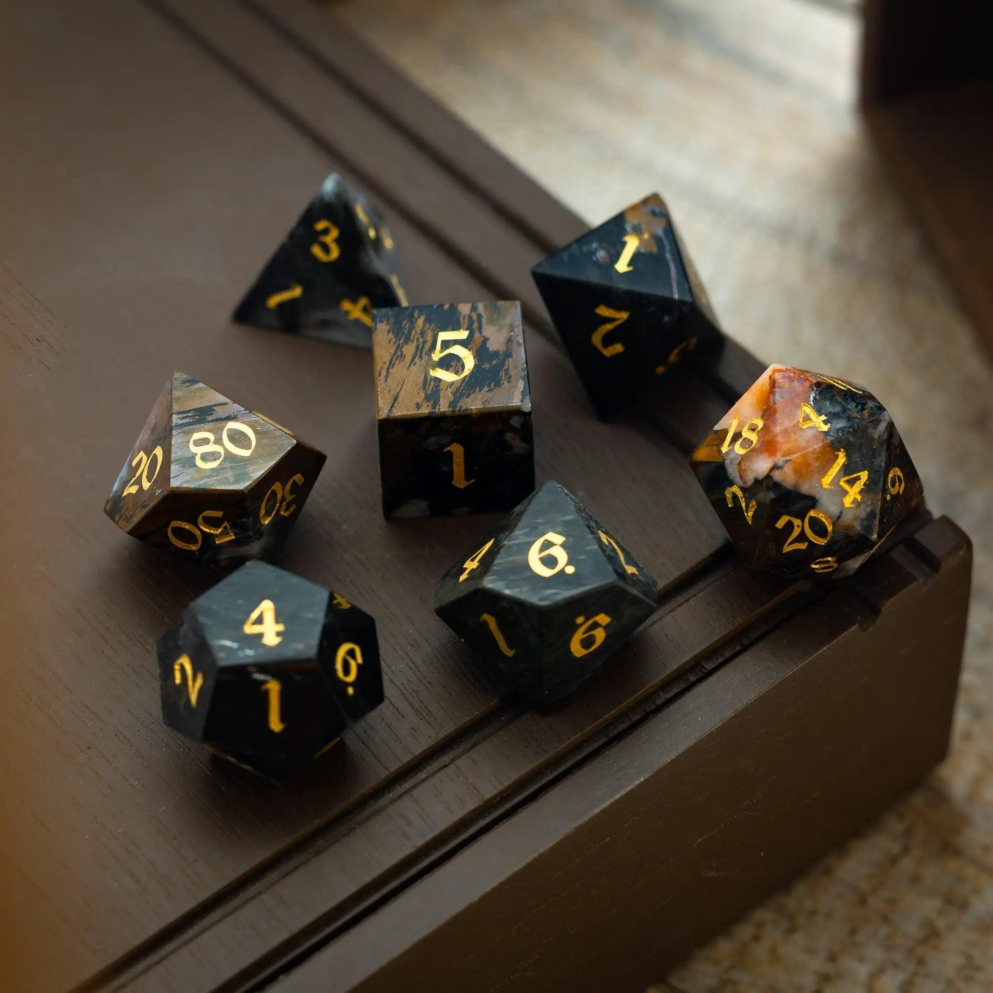 Black gemstone eagle eye DND dice set by Runic Dice, hand-carved gemstone dice featuring eagle eye design for tabletop gaming.