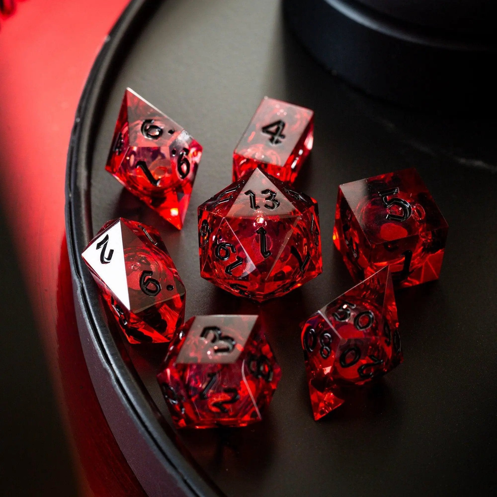 Blood red glitter liquid core resin DND dice set by Runic Dice, handmade with vibrant red and sparkling glitter details.