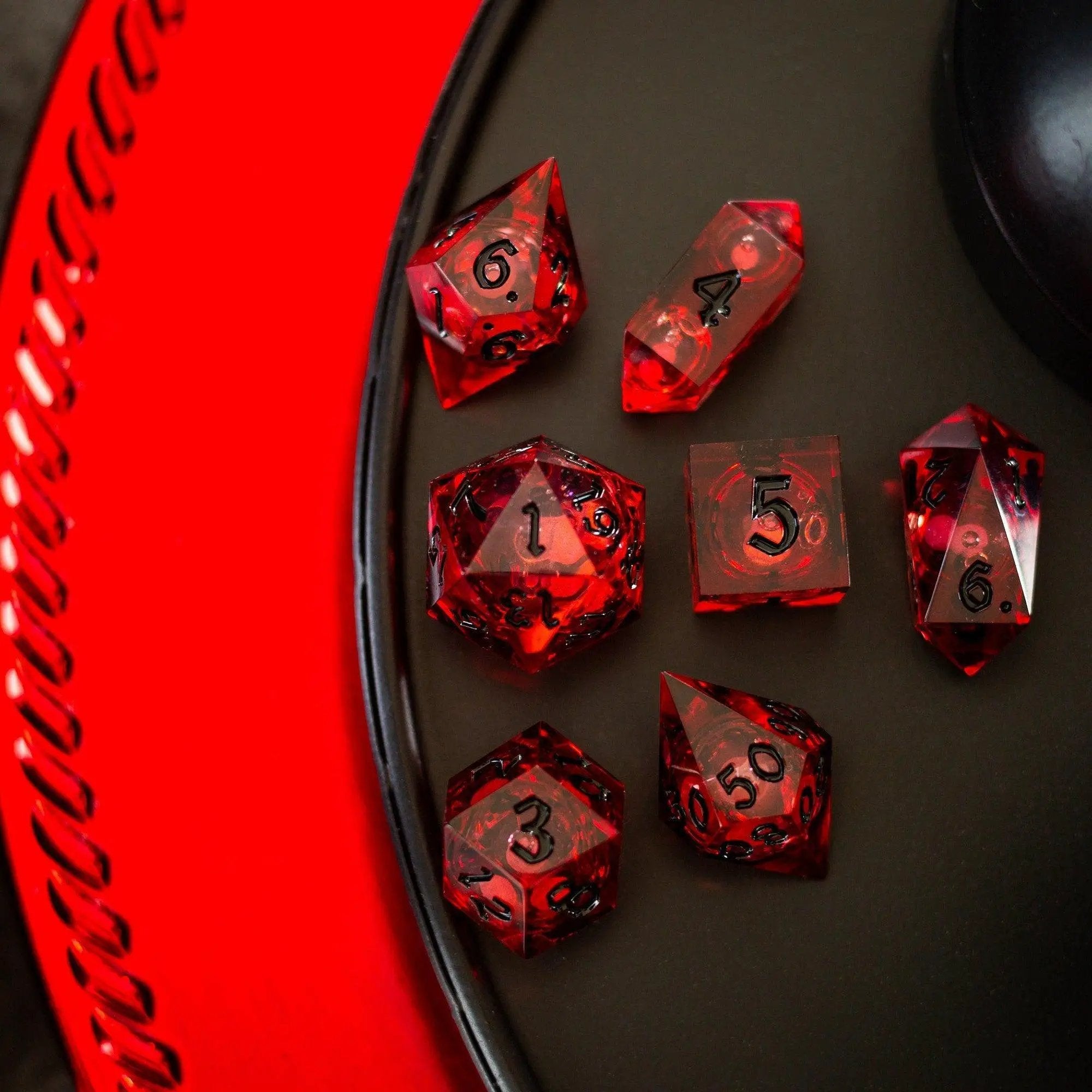 Blood red glitter liquid core handmade resin DND dice set by Runic Dice, featuring vibrant red and sparkling glitter details.