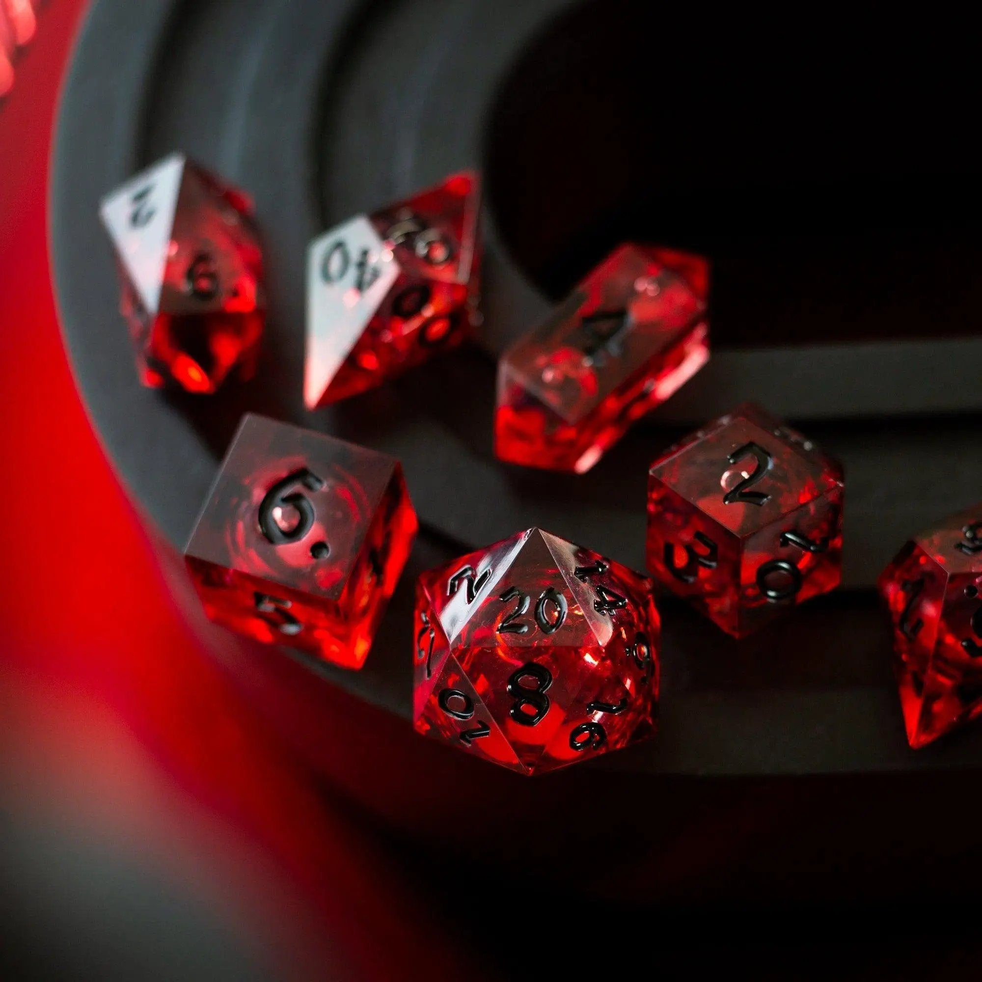 Blood red glitter liquid core handmade resin DND dice set by Runic Dice, featuring vibrant, shimmering red and clear resin.