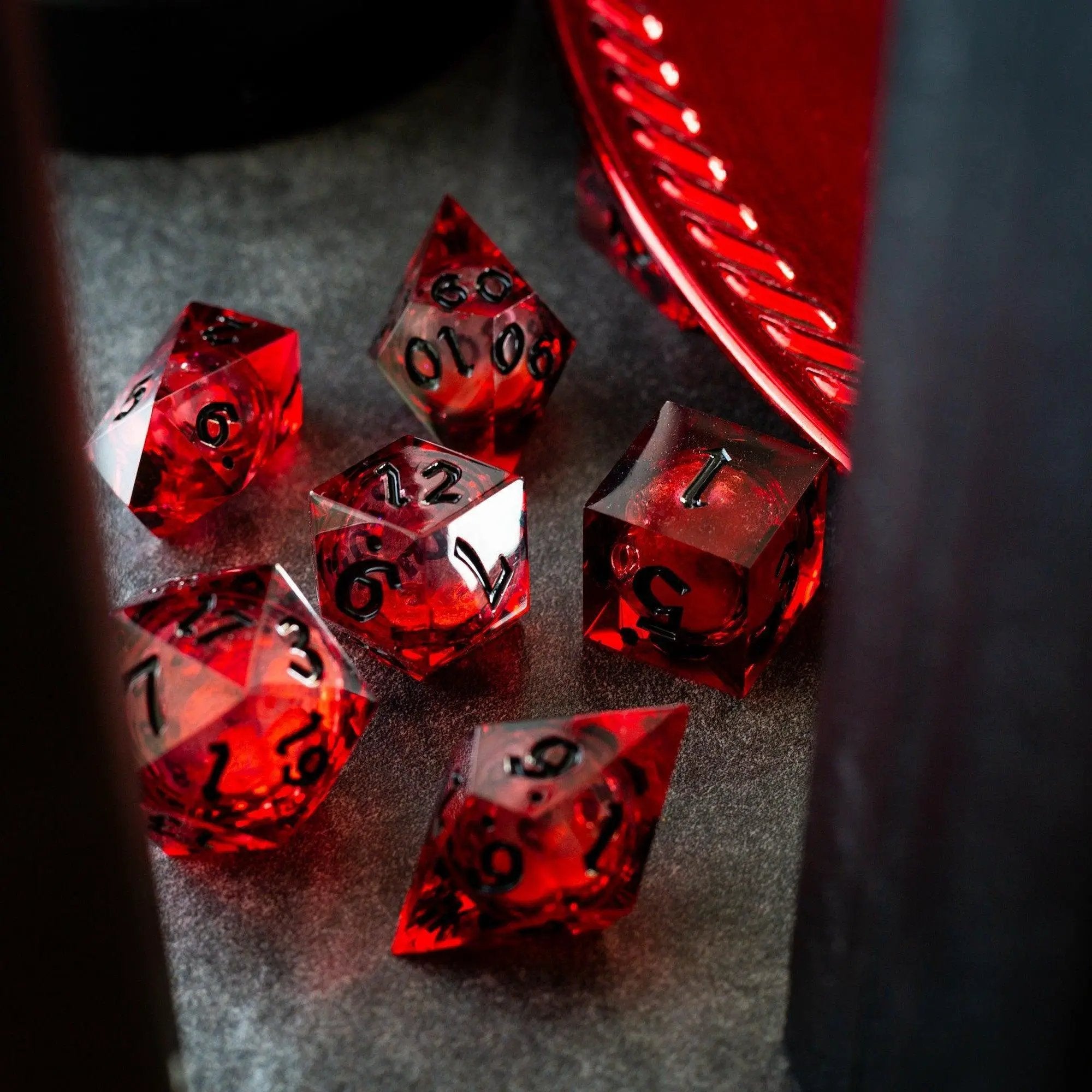 Blood red glitter liquid core handmade resin DND dice set by Runic Dice, featuring vibrant red and glittery details.