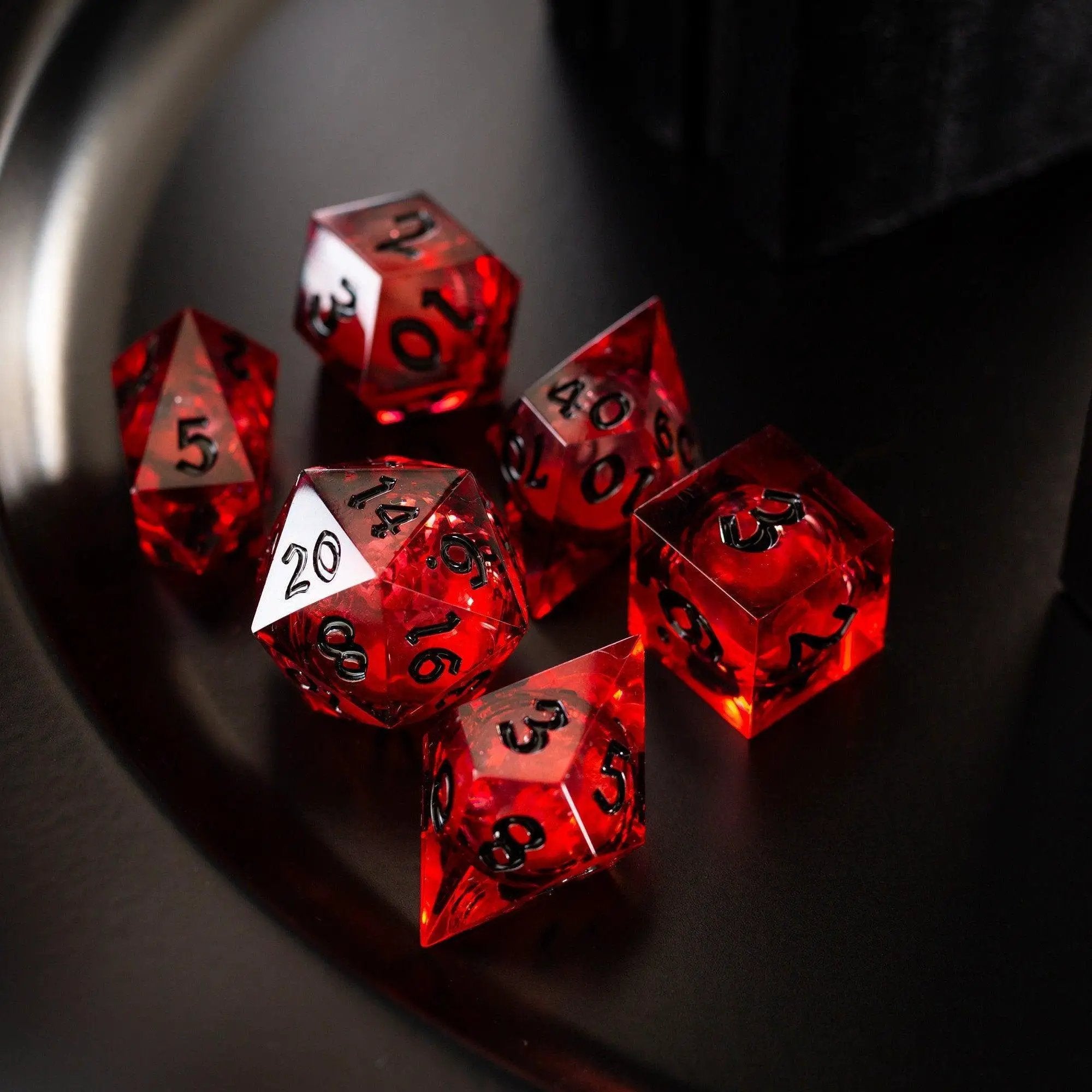 Blood red glitter liquid core handmade resin D&D dice set by Runic Dice, featuring vibrant red and glitter accents.