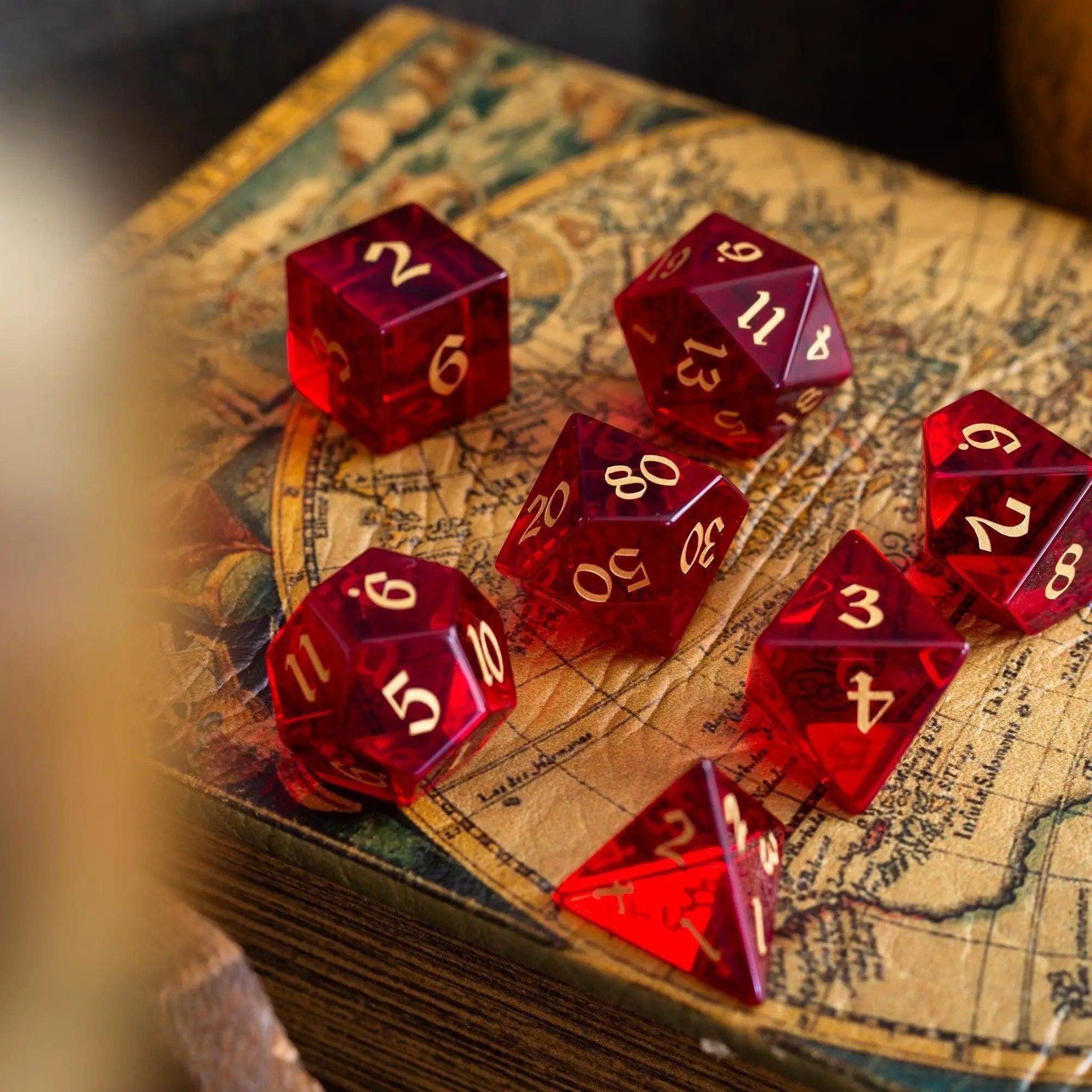Blood-red hand-carved zircon gemstone DND dice set by Runic Dice, featuring vivid glass dice with intricate carvings.