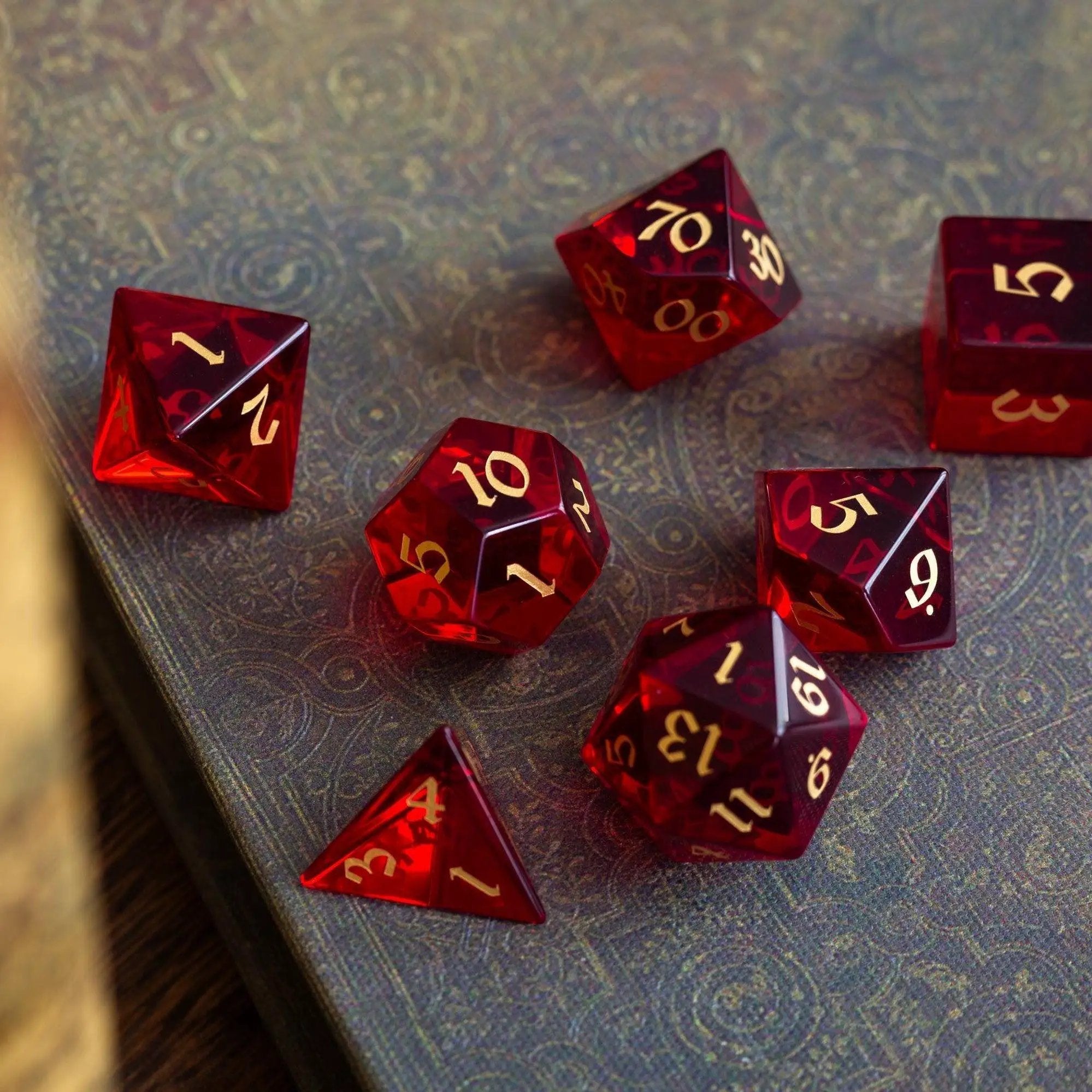 Blood-red hand-carved zircon gemstone DND dice set by Runic Dice with intricate craftsmanship and vibrant color.
