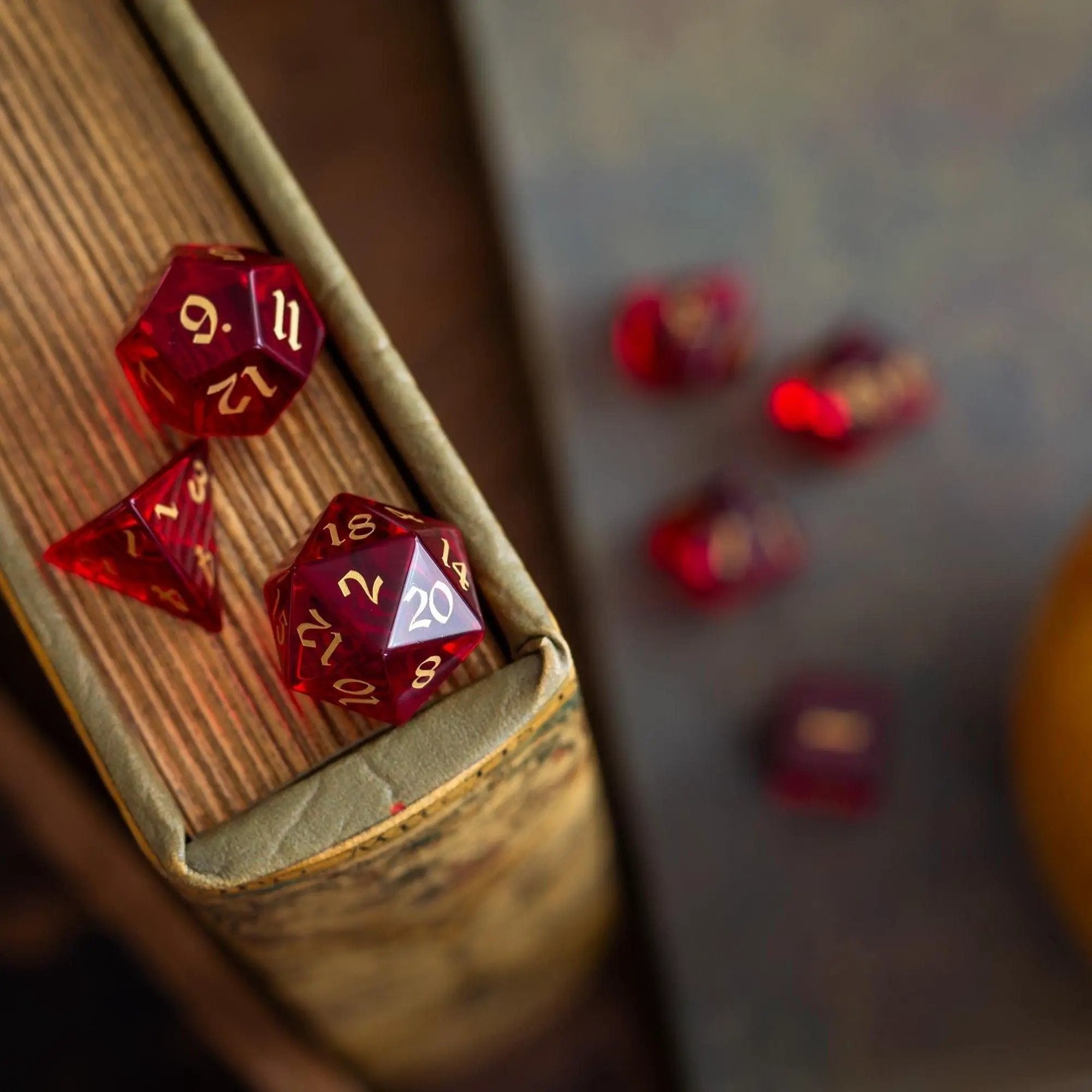 Blood red hand-carved zircon glass gemstone dice set for DND, featuring intricate craftsmanship by Runic Dice.