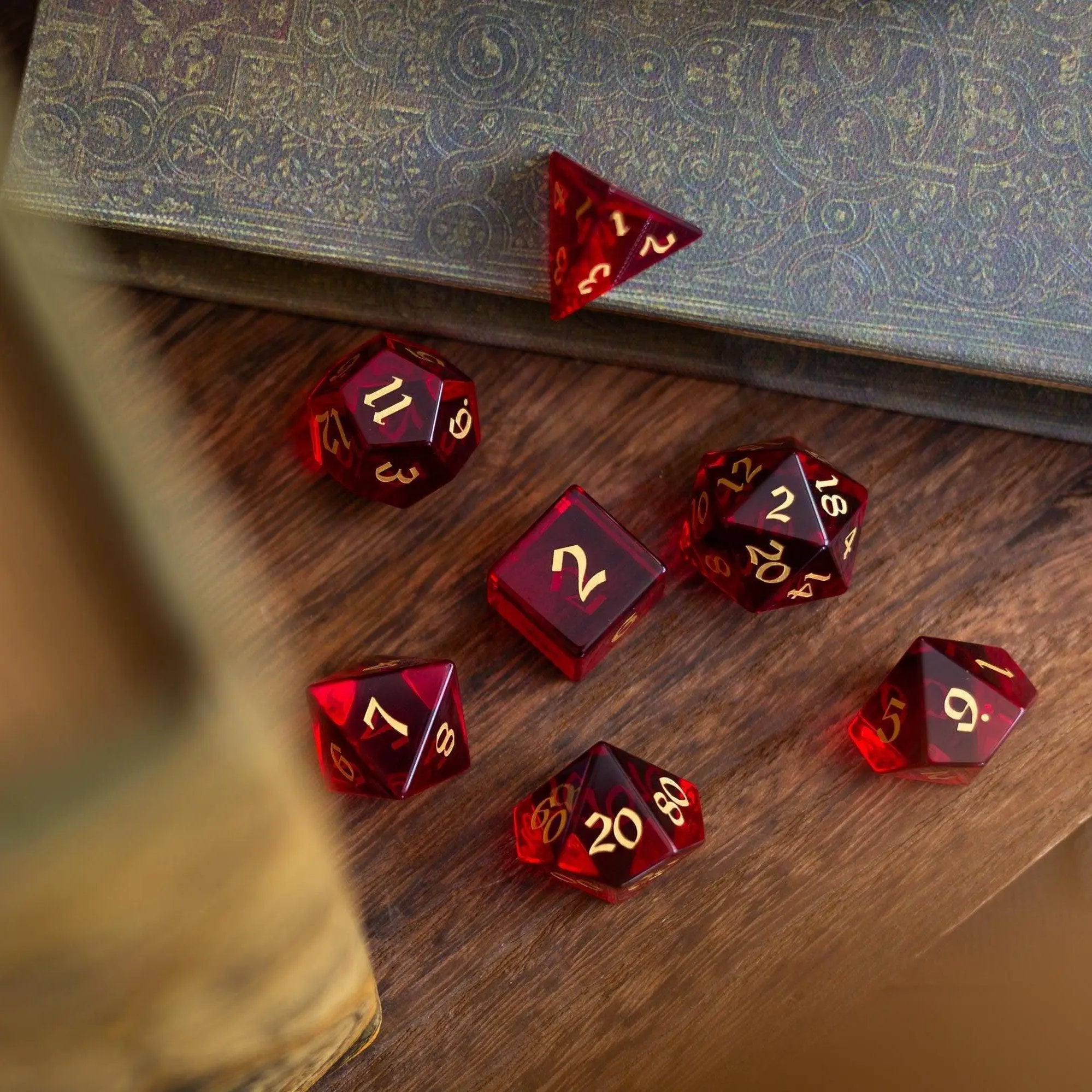 Blood red hand-carved zircon glass DND dice set by Runic Dice, featuring gemstone dice with intricate carvings.