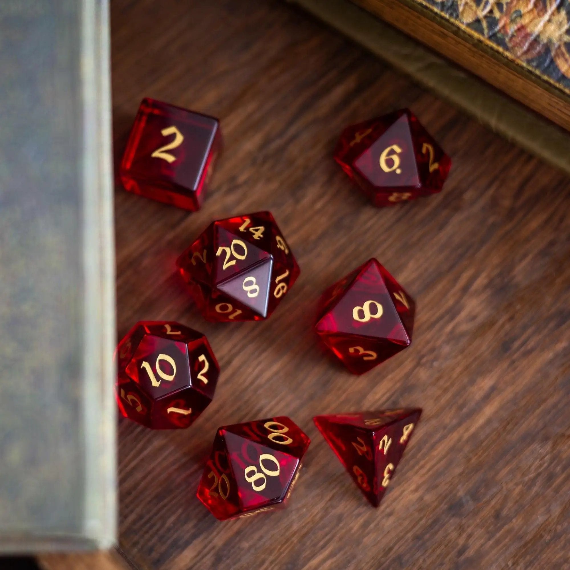 Blood red hand-carved zircon glass DND dice set by Runic Dice, featuring gemstone polyhedral gaming dice for tabletop RPGs.