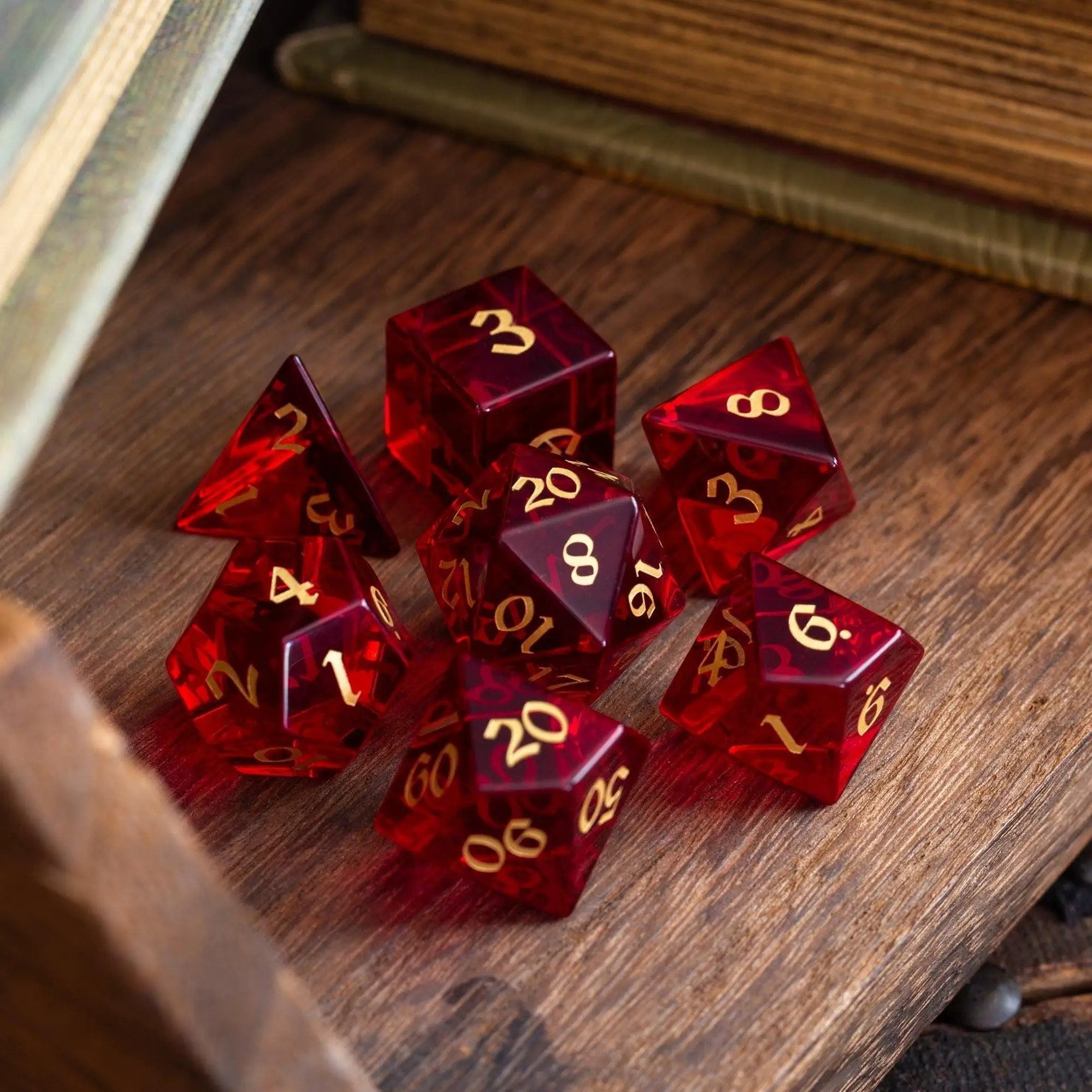 Blood red hand-carved zircon glass DND gemstone dice set by Runic Dice, featuring intricate design and vibrant color.