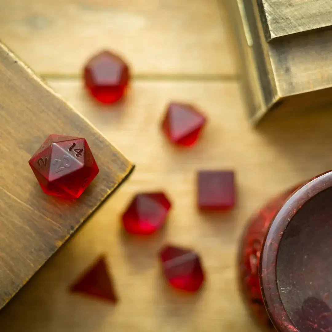 Blood red raised zircon glass gemstone DND dice set with hand-carved details by Runic Dice.