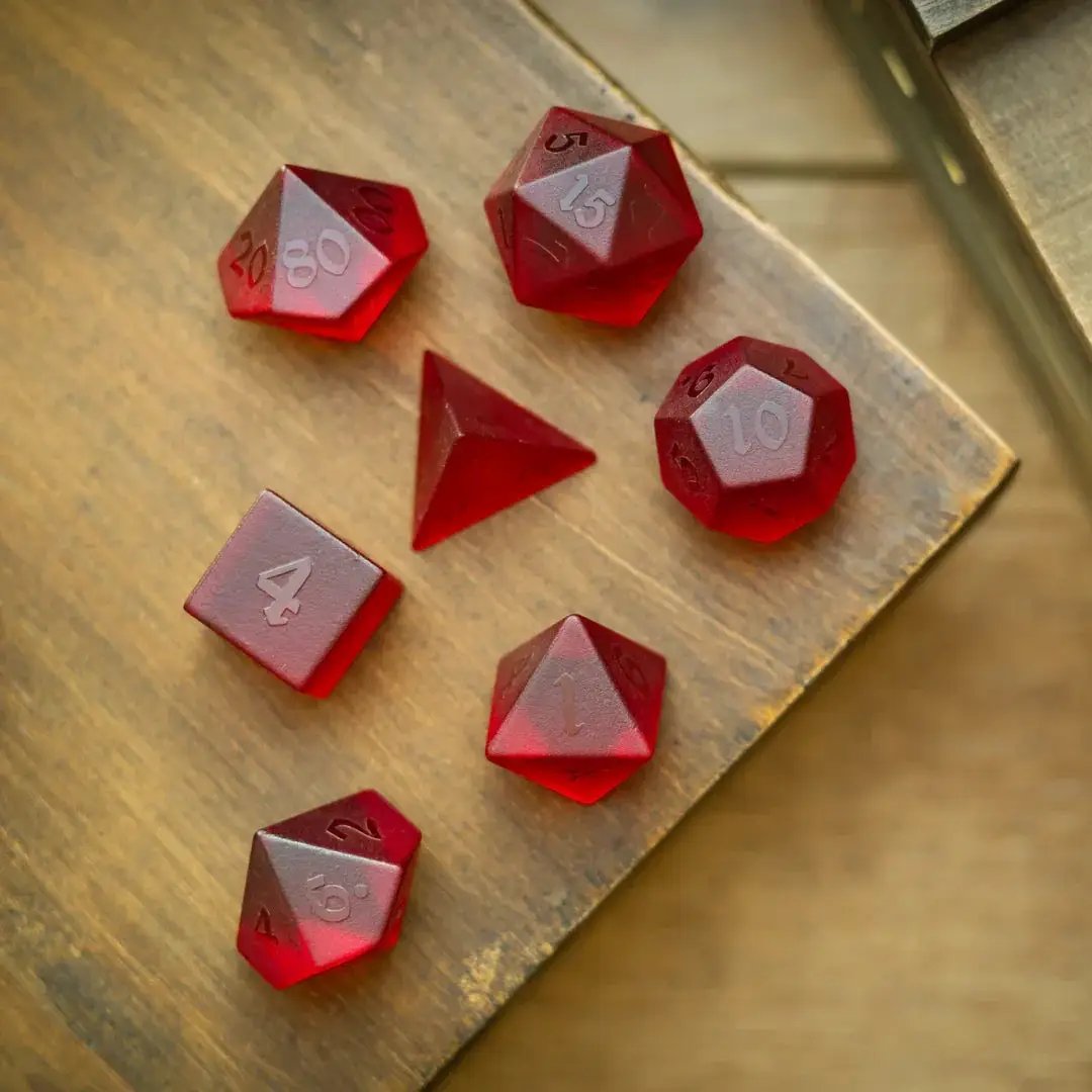 Blood red raised zircon gemstone DND dice set by Runic Dice, hand-carved glass dice for tabletop gaming.
