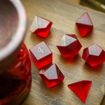 Blood red raised zircon glass gemstone DND dice set by Runic Dice, hand-carved with intricate details for tabletop gaming.