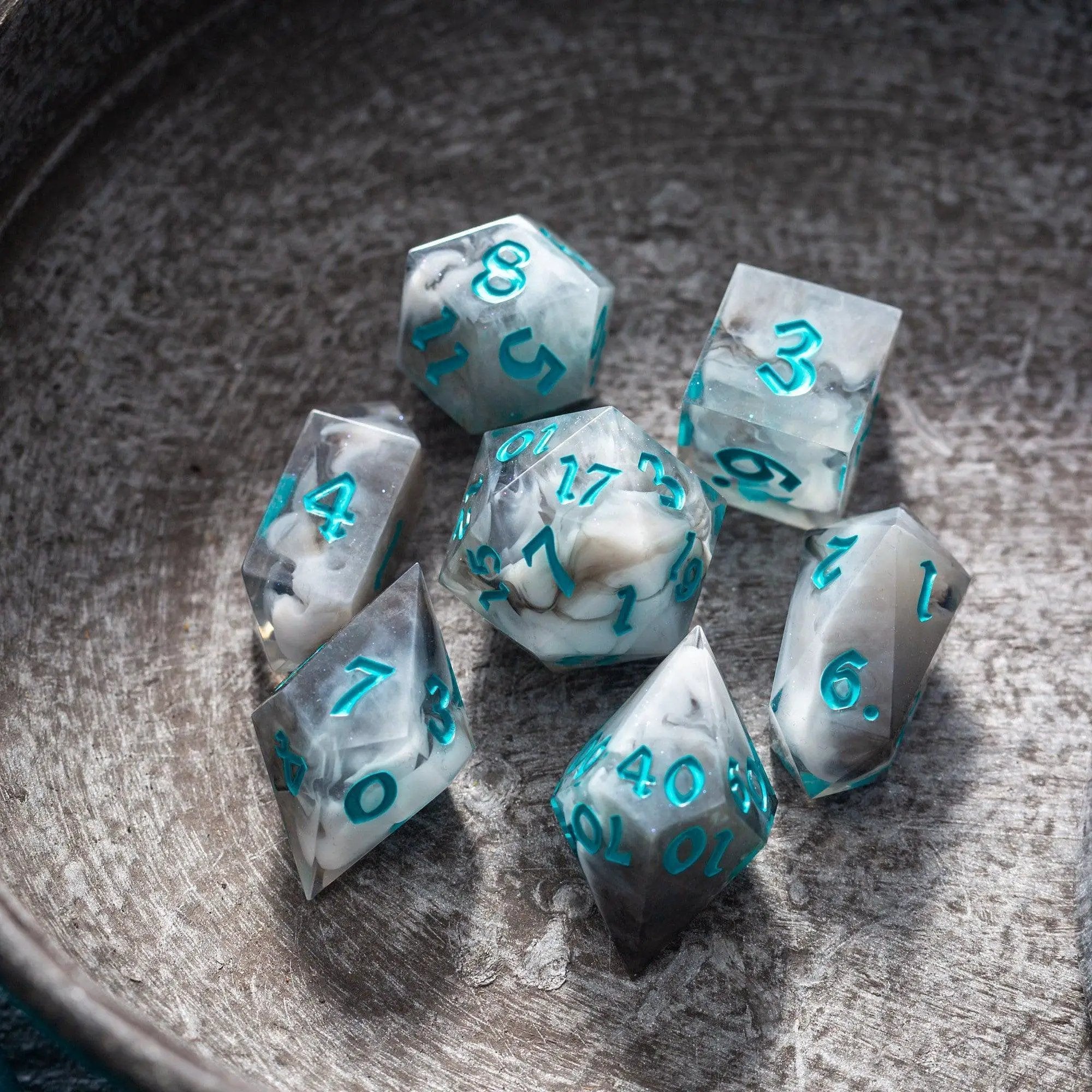 Blue cloud-themed handmade resin DND dice set by Runic Dice, featuring six colorful, intricately designed polyhedral dice.