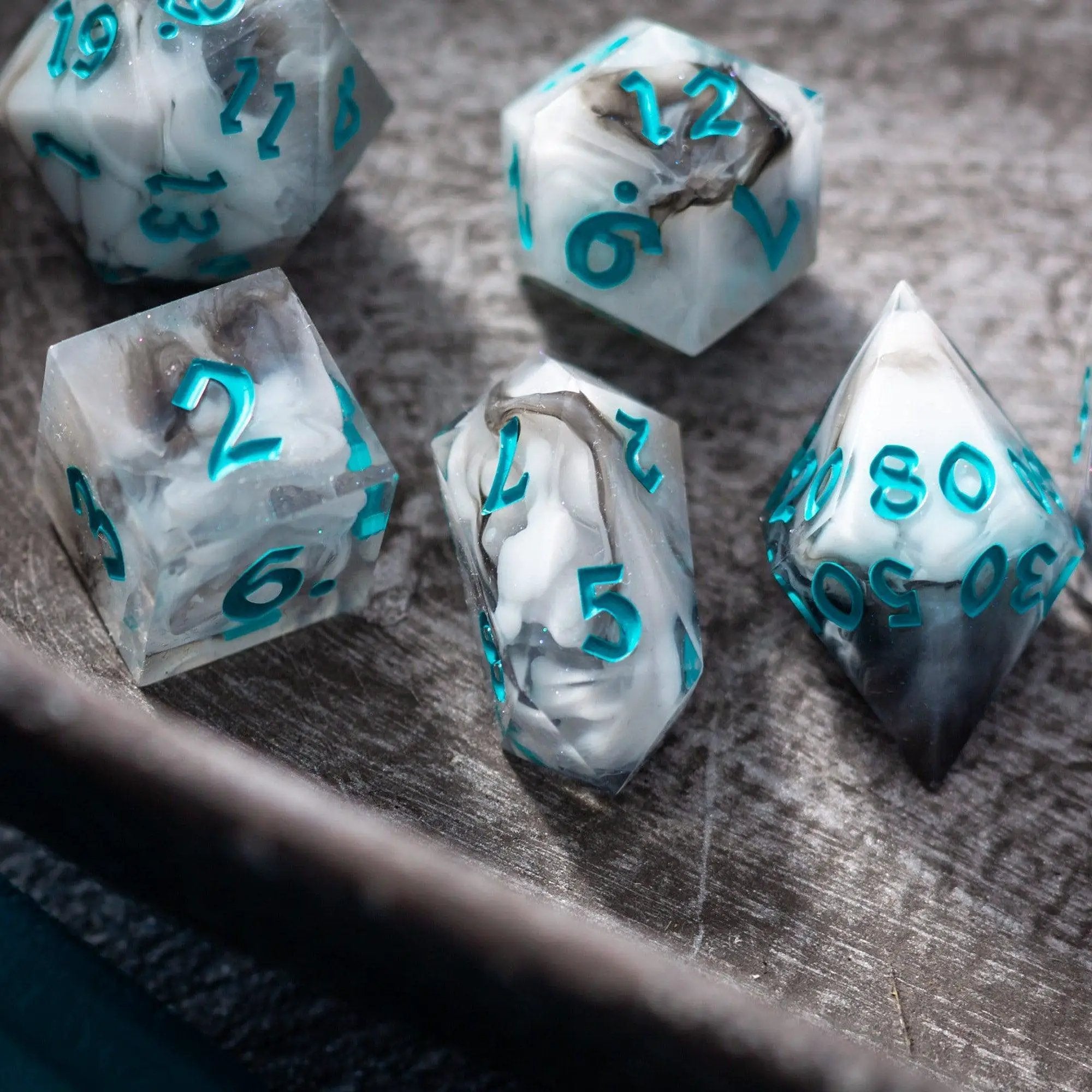Blue cloud handmade resin DND dice set by Runic Dice, featuring vibrant blue and clear resin with gold numbering for tabletop gaming.