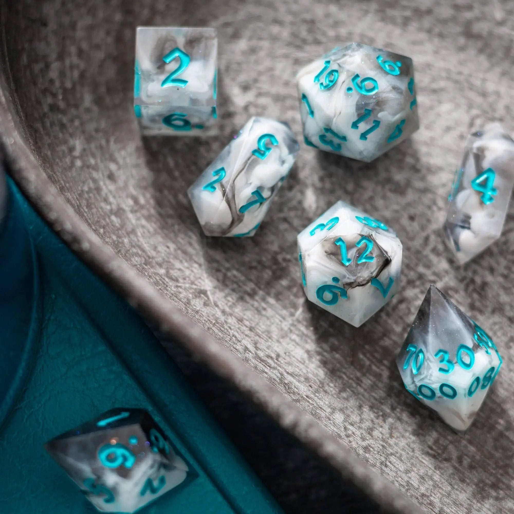 Blue cloud-themed handmade resin DND dice set by Runic Dice, featuring a mix of blue and cloud-like swirls in each die.