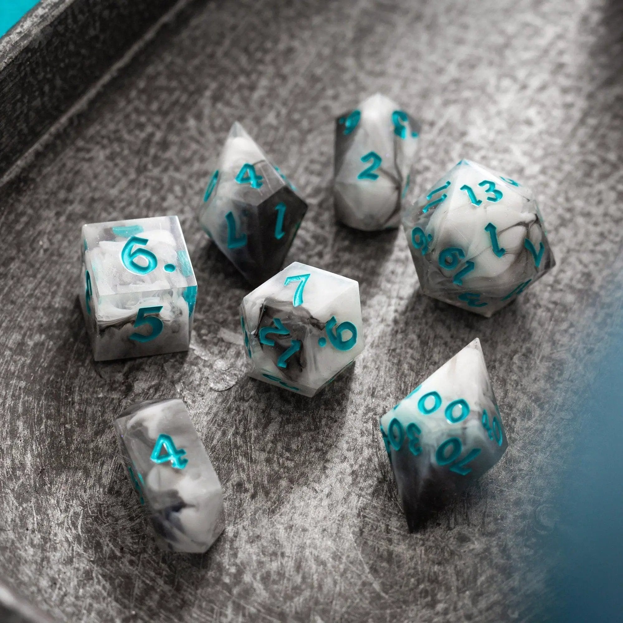 Blue cloud-themed handmade resin DND dice set by Runic Dice, featuring intricately crafted, colorful polyhedral gaming dice.