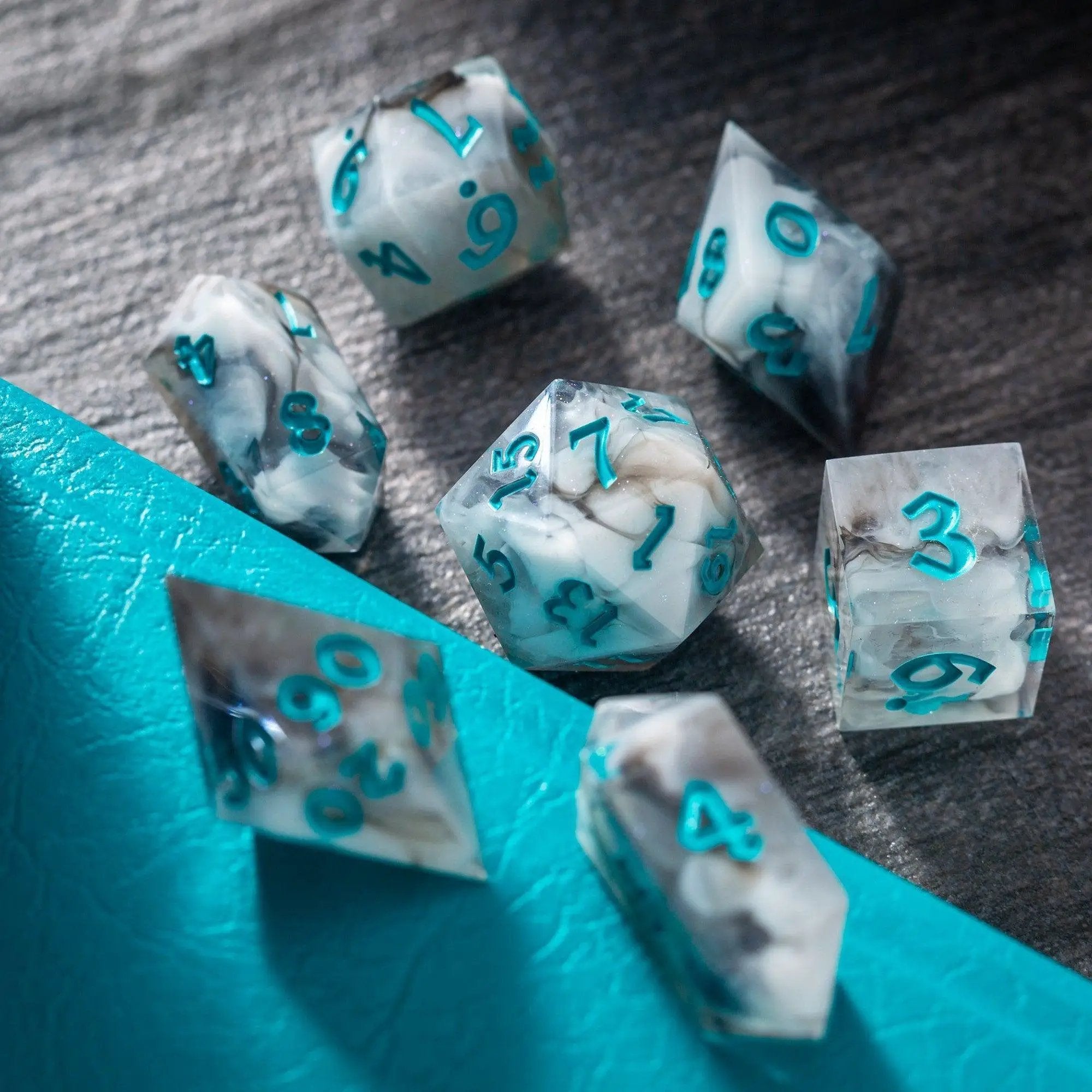 Blue cloud-themed handmade resin DND dice set from Runic Dice, featuring various multi-sided resin gaming dice.