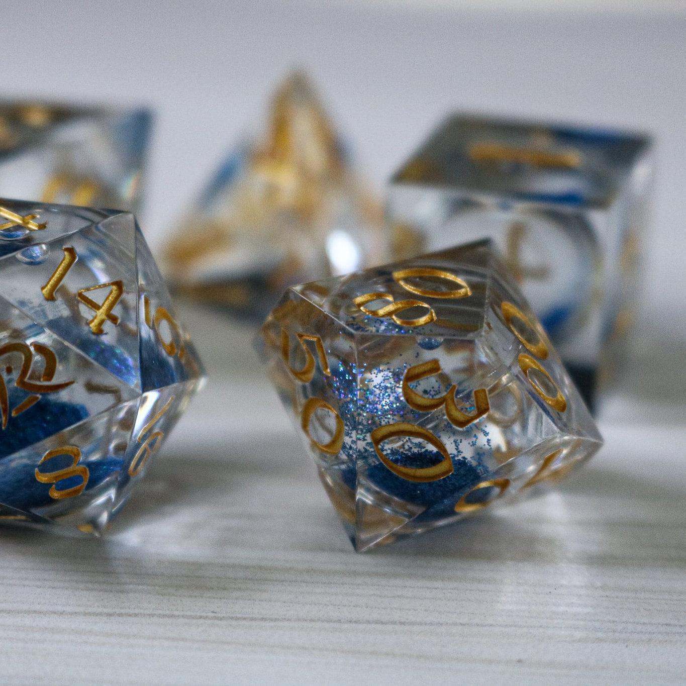 Blue glitter liquid core resin D&D dice set with sharp edges by Runic Dice, handmade for tabletop gaming.