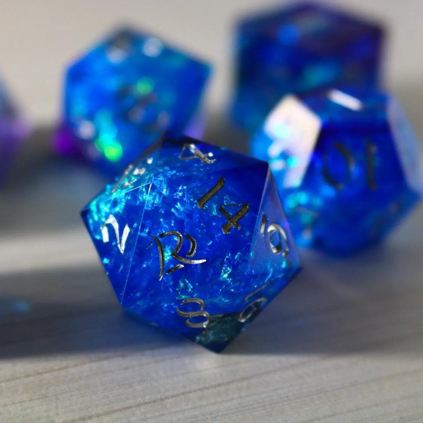 Blue handmade resin DND dice set with sharp edges, featuring vibrant blue color and intricate design by Runic Dice.