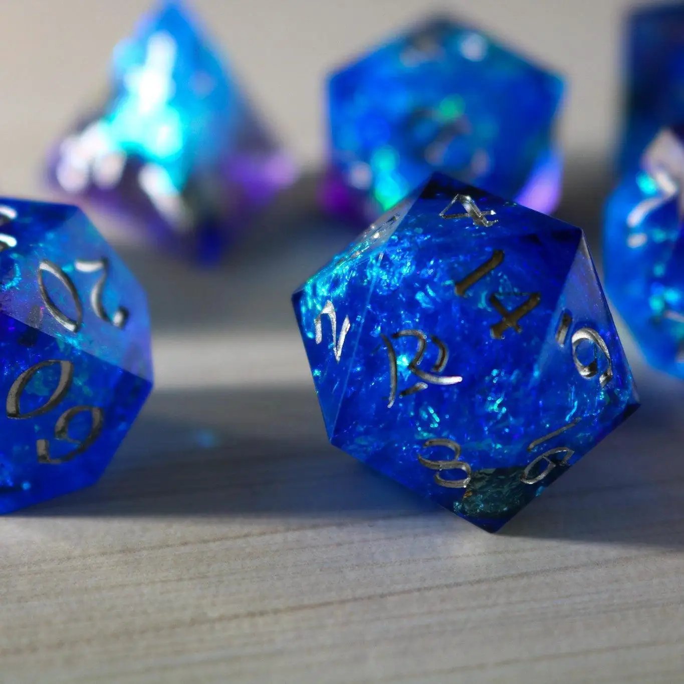 Blue handmade resin DND dice set with sharp edges, featuring vibrant blue color and intricate detailing by Runic Dice.