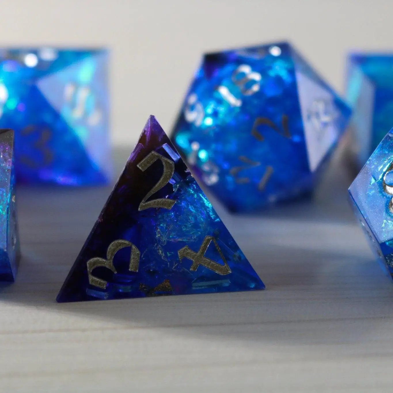 Blue handmade resin DND dice set with sharp edges, featuring numbered faces in vibrant blue color by Runic Dice.