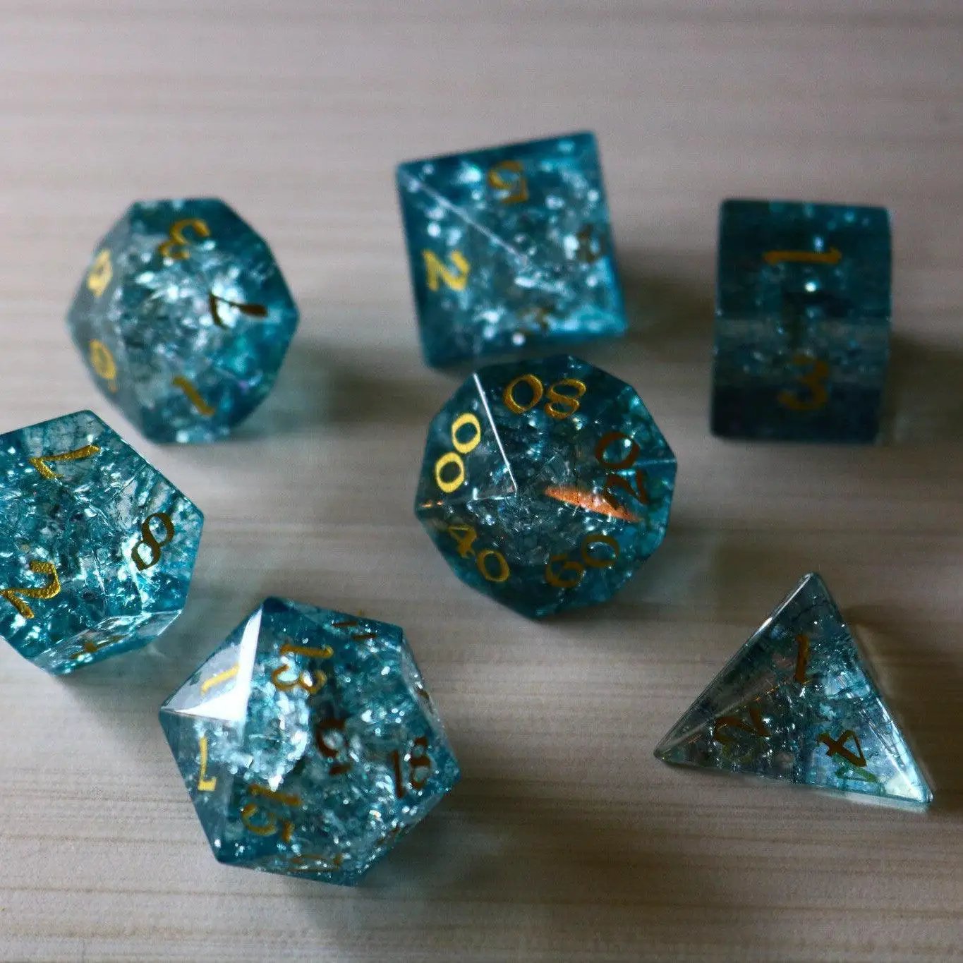 Blue Ocean Forge fire glass gemstone DND dice set by Runic Dice, featuring vibrant blue and fiery orange hues in a gemstone design.