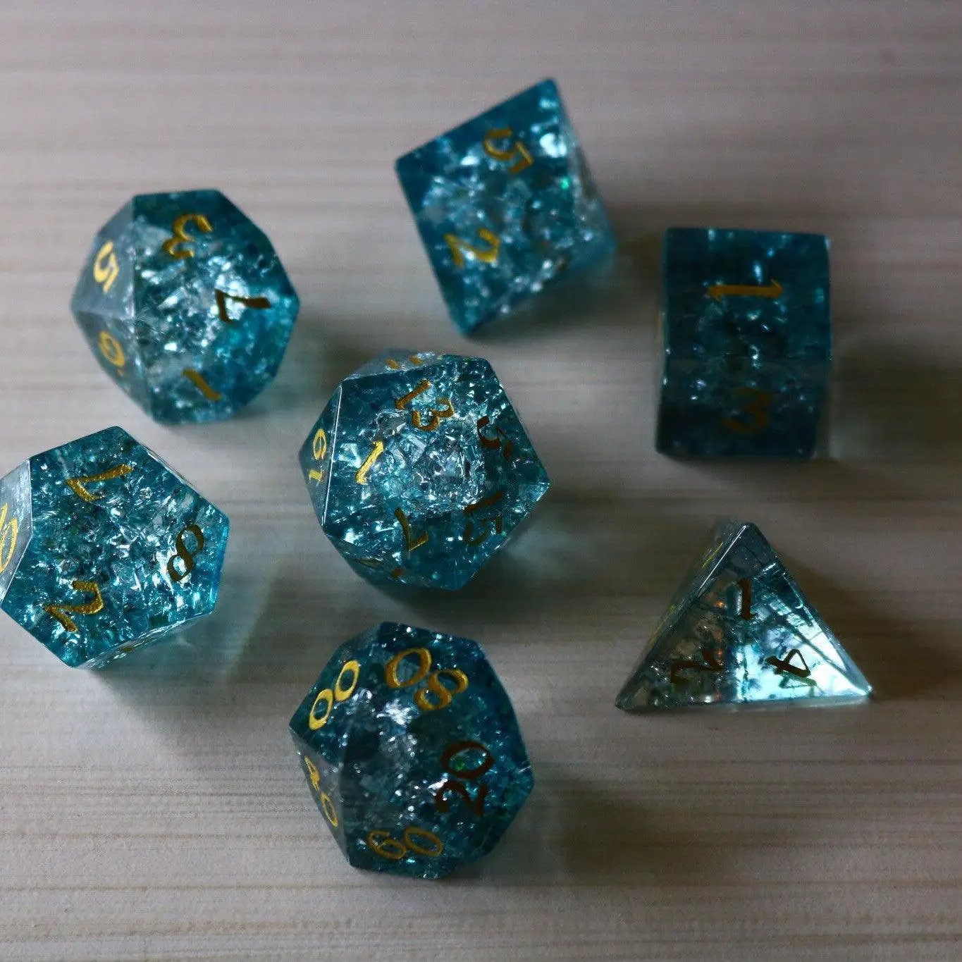 Blue Ocean Forge Fire Glass DND gemstone dice set by Runic Dice, featuring vibrant blue and fiery orange tones with intricate designs.