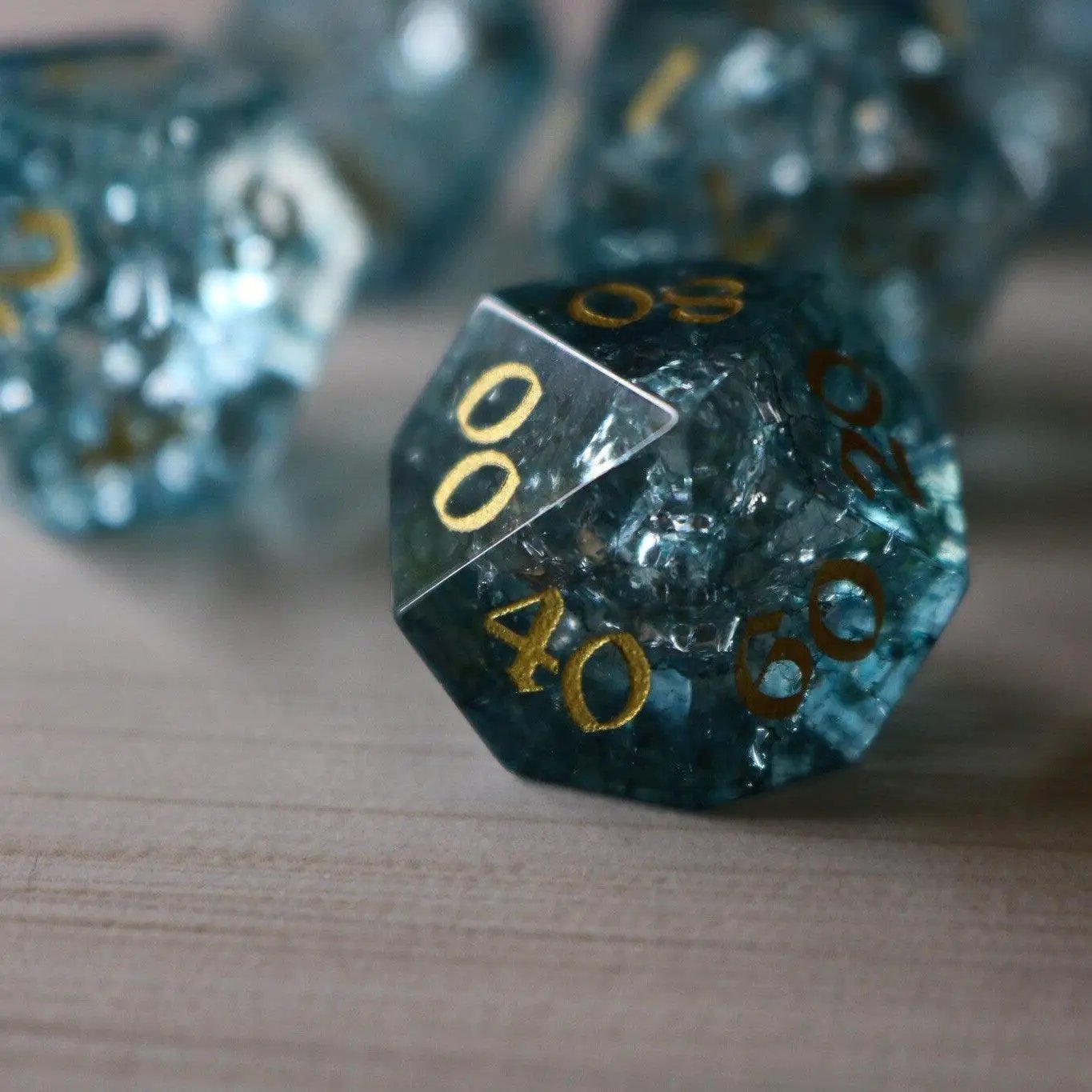 Blue Ocean Forge fire glass gemstone DND dice set by Runic Dice, featuring vibrant blue and fiery orange gemstone dice.