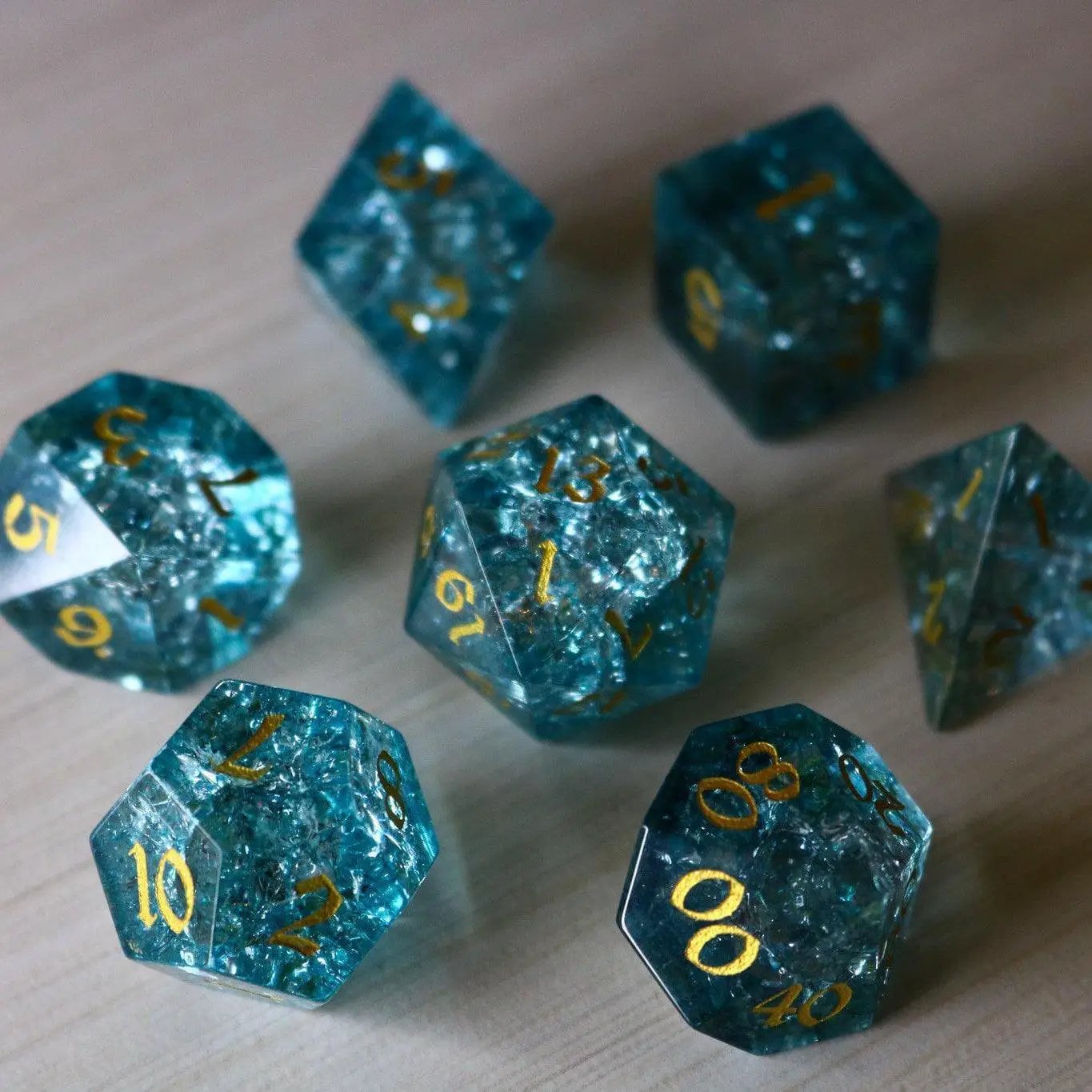 Blue Ocean Forge fire glass gemstone D&D dice set by Runic Dice, featuring vibrant blue and fiery design elements.