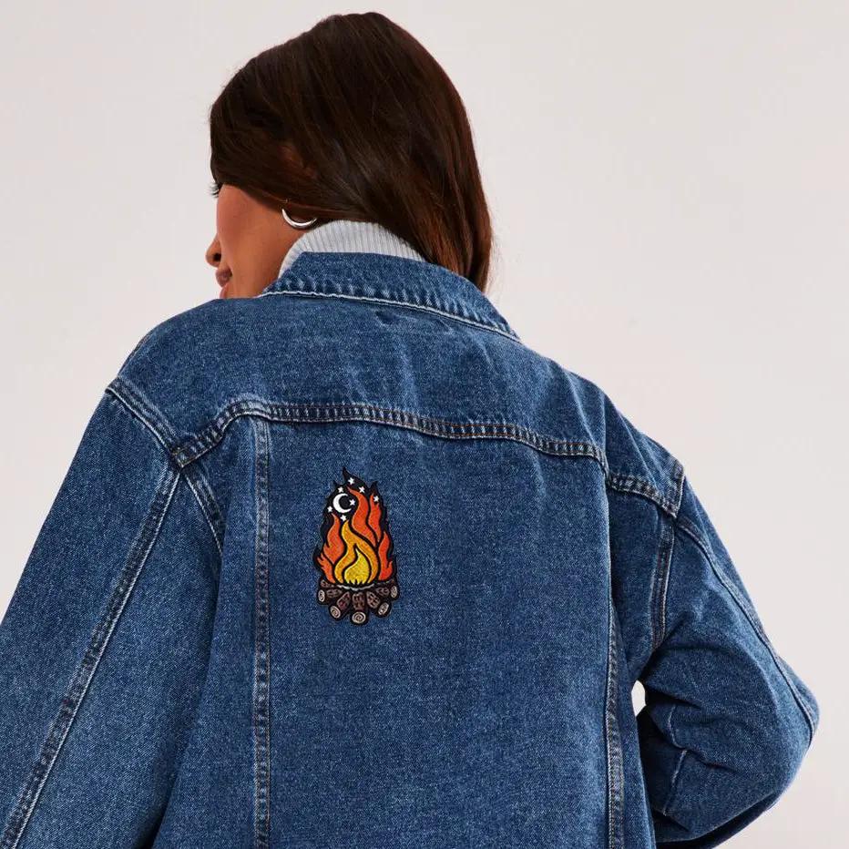 Kolorspun Campfire patch featuring a colorful embroidered design of a campfire with logs and flames.