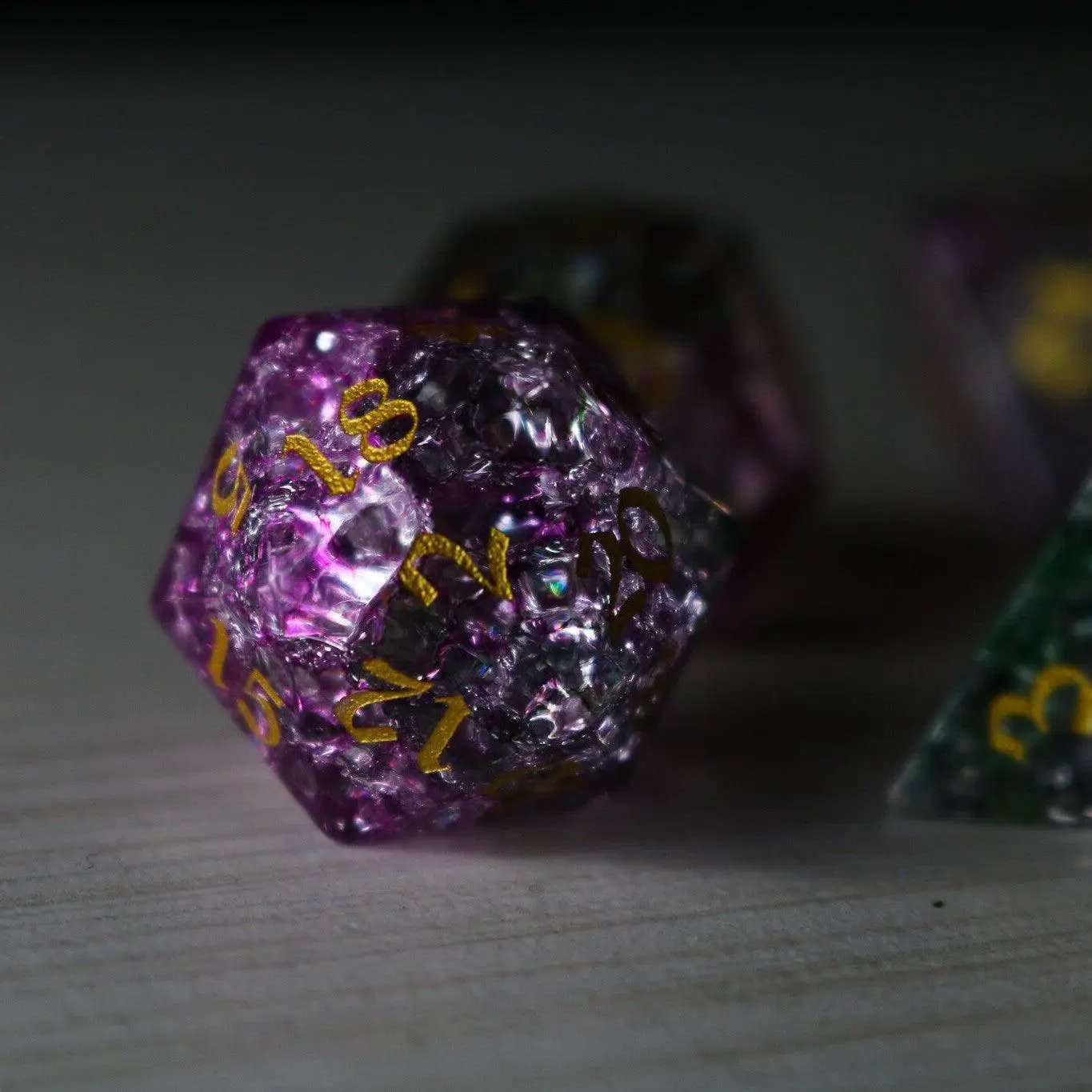 Dark Nox Forge Fire Glass DND gemstone dice set by Runic Dice, featuring fiery-colored translucent resin with engraved numbers.