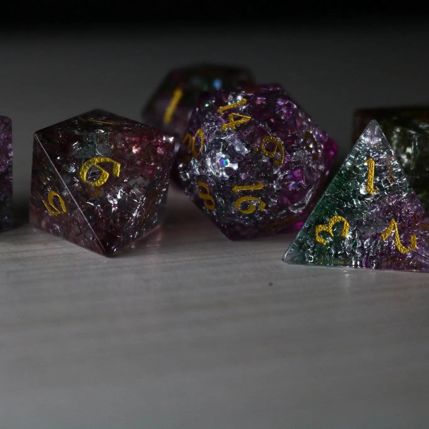 Dark Nox Forge Fire Glass DND dice set by Runic Dice featuring gemstone dice with fiery red and black swirls.