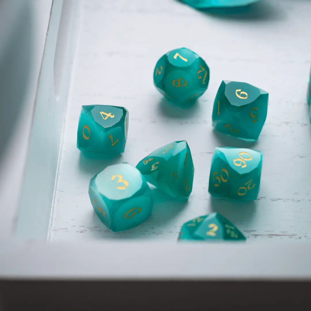 Runic Dice dwarf-cut aquamarine cat’s eye gemstone DND dice set with polished, vibrant blue dice featuring intricate carvings.