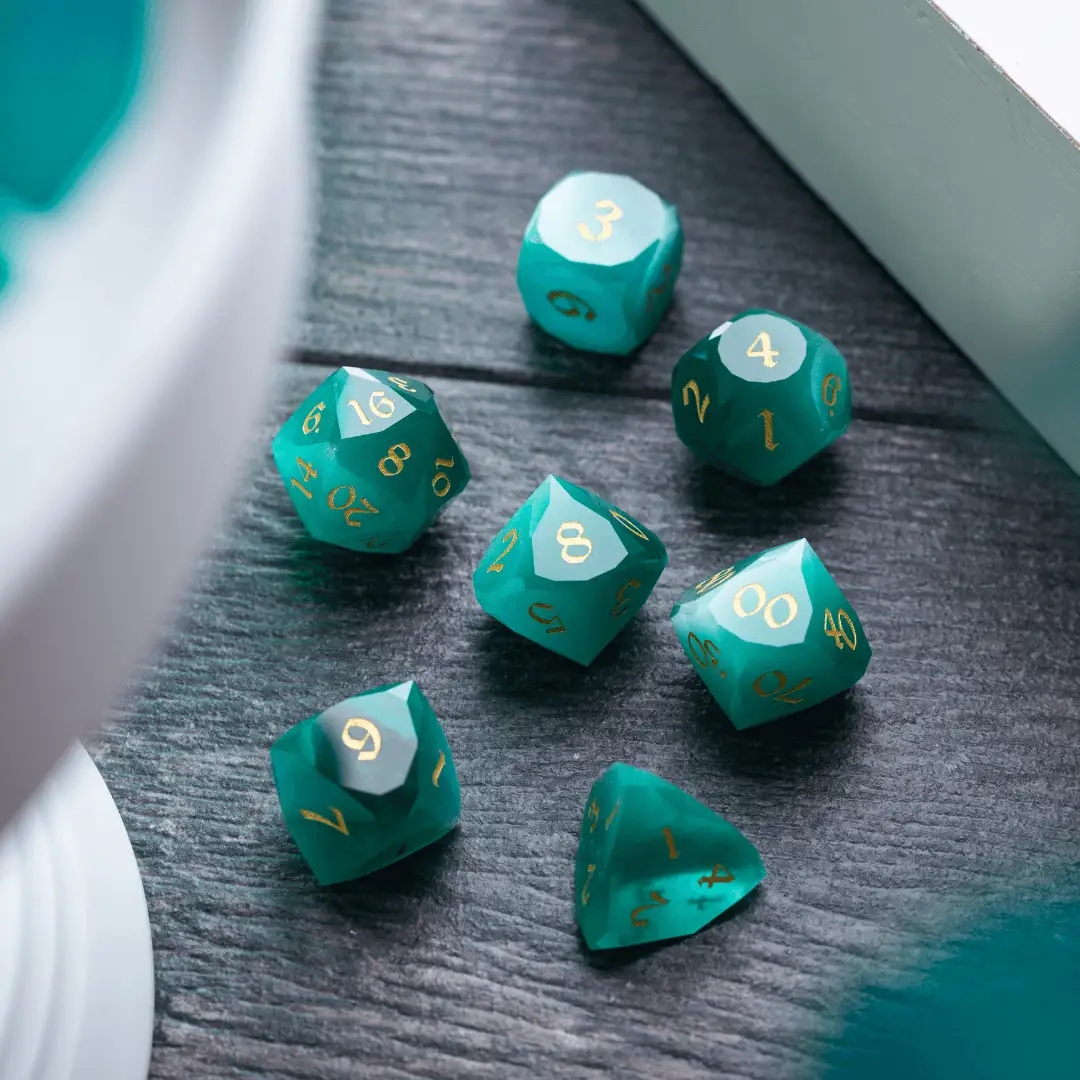 Runic Dice dwarf-cut aquamarine cat’s eye gemstone DND dice set showing six polished gemstone dice with intricate carvings.