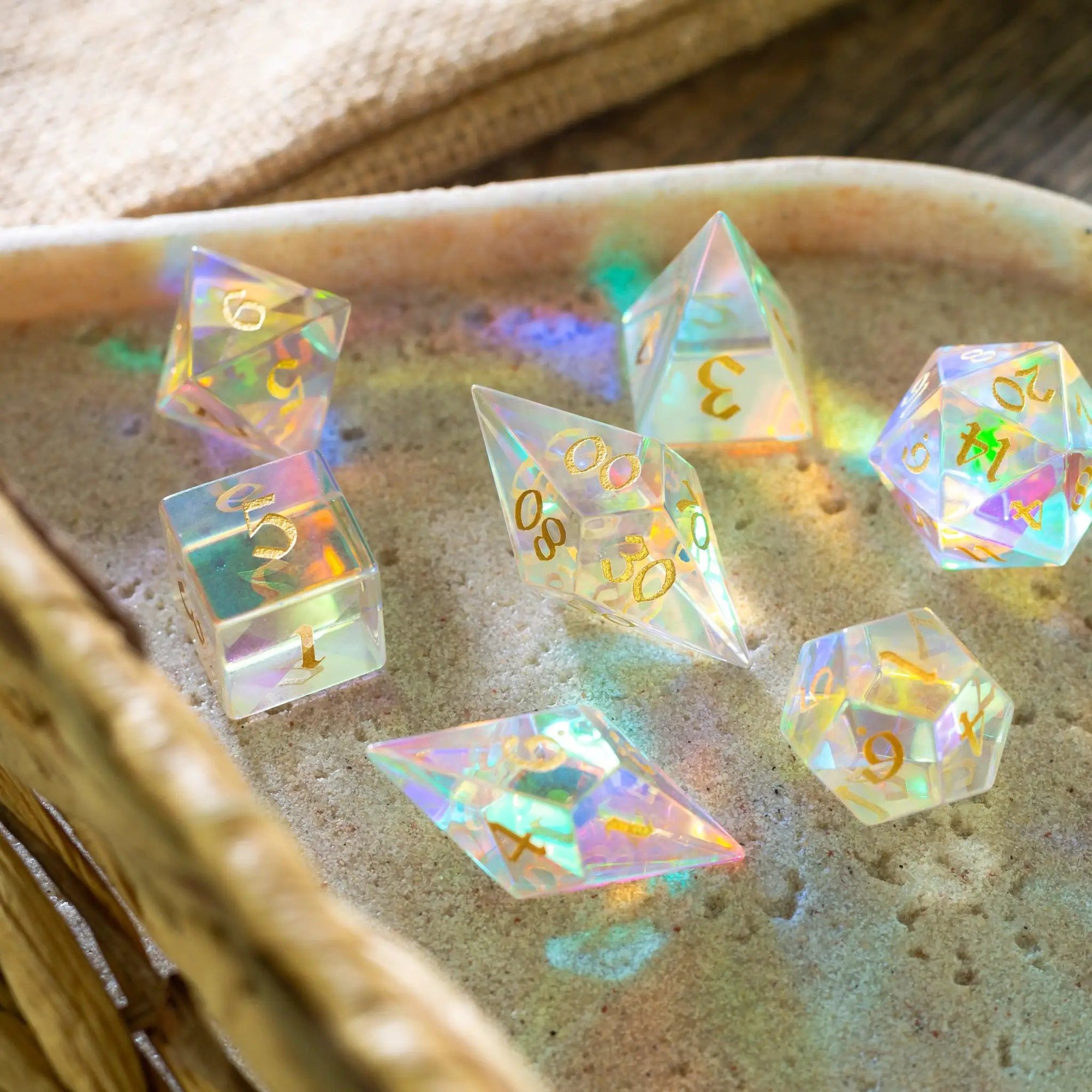 Set of gemstone dichroic glass Elven cut DND dice from Runic Dice, featuring vibrant, shimmering colors and intricate Elven design.