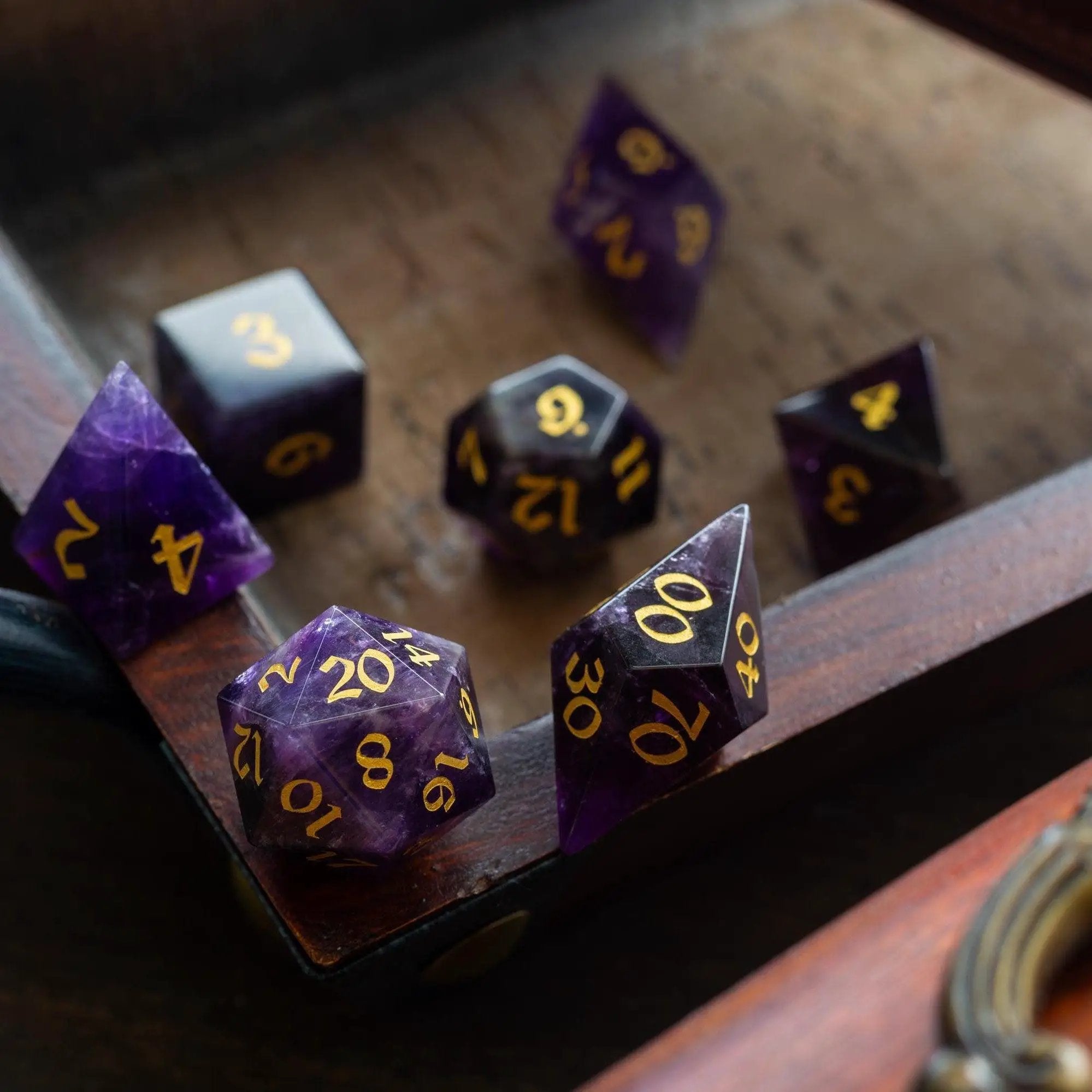 Purple amethyst gemstone DND dice set with elven cut design by Runic Dice, featuring polished, faceted gemstone dice for tabletop gaming.
