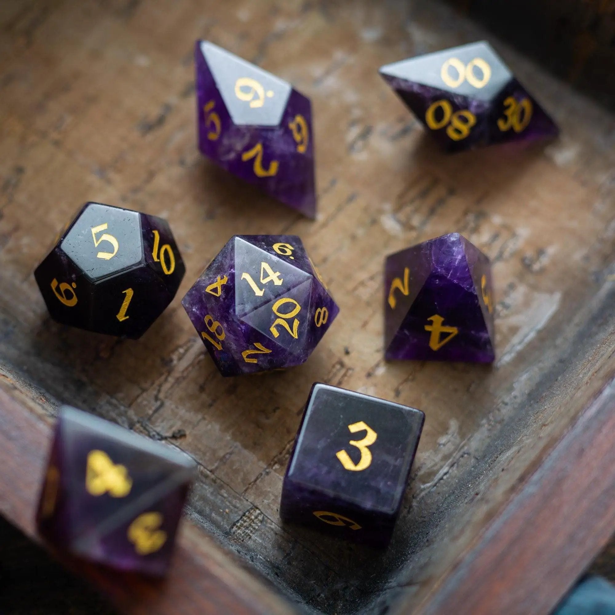 Purple amethyst gemstone DND dice set with elven cut design from Runic Dice, featuring polished, faceted gemstone dice for tabletop gaming