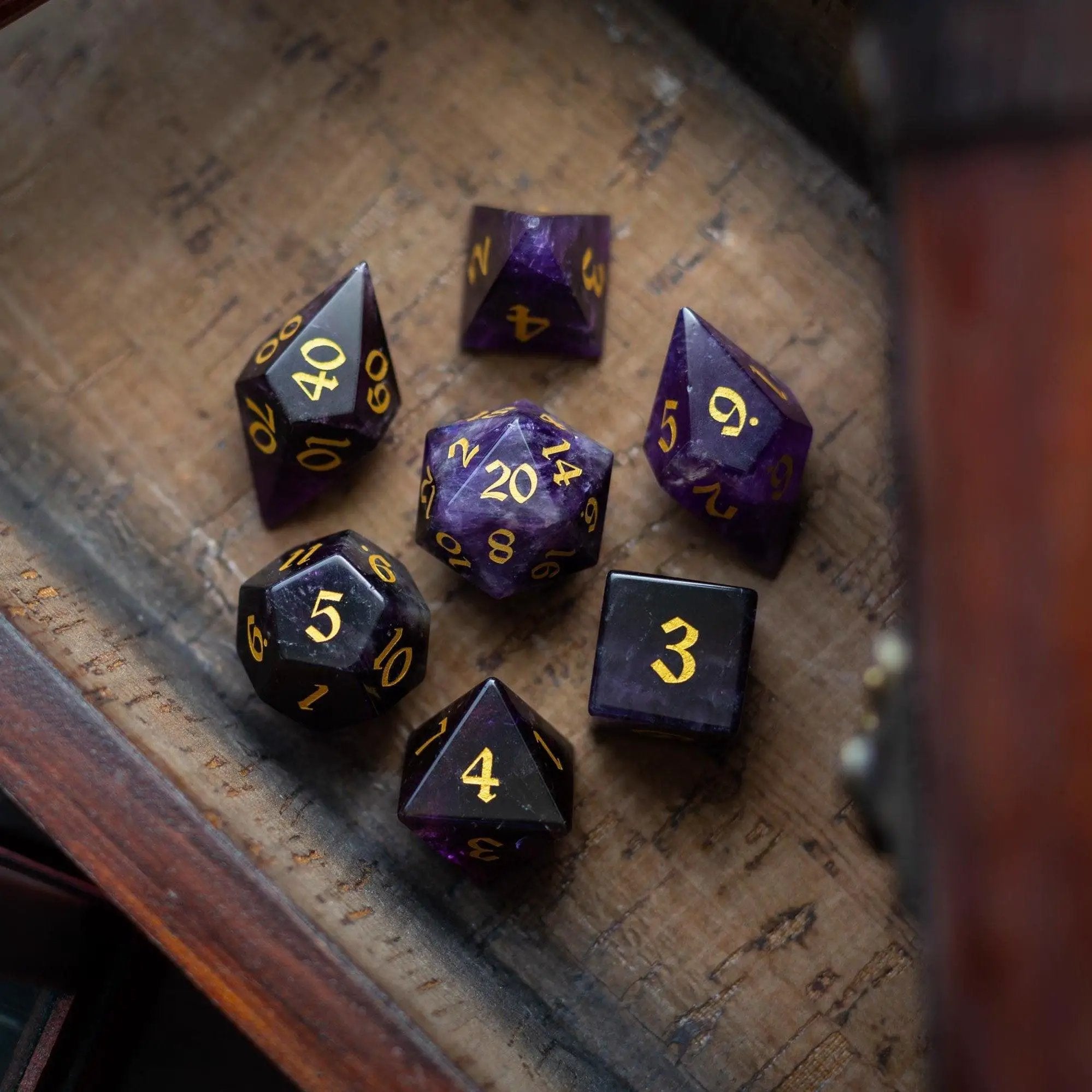Purple amethyst gemstone DND dice set with elven cut design from Runic Dice, featuring intricately carved gemstone dice.