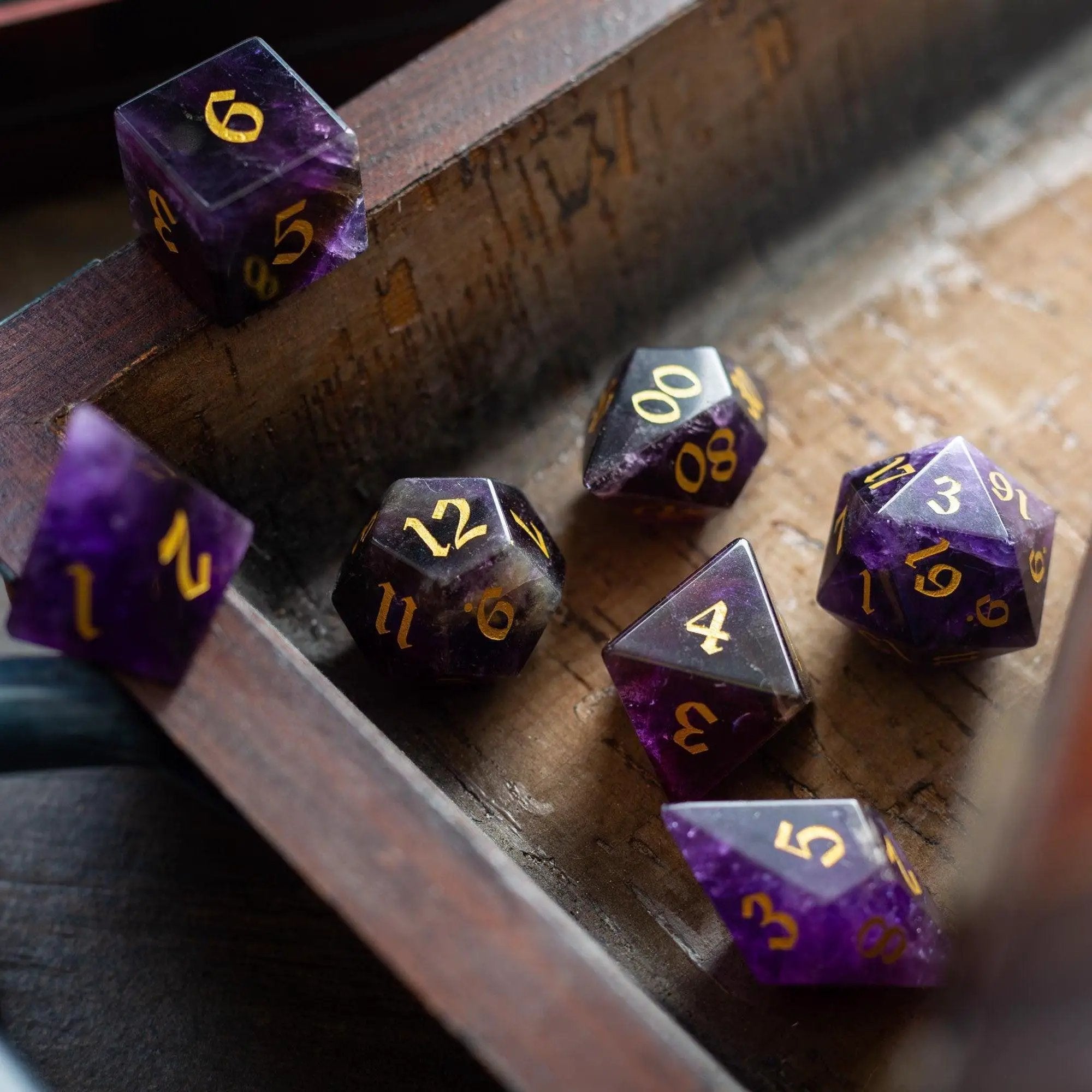 Purple amethyst gemstone DND dice set with elven cut design from Runic Dice, featuring six intricately crafted gemstone dice.
